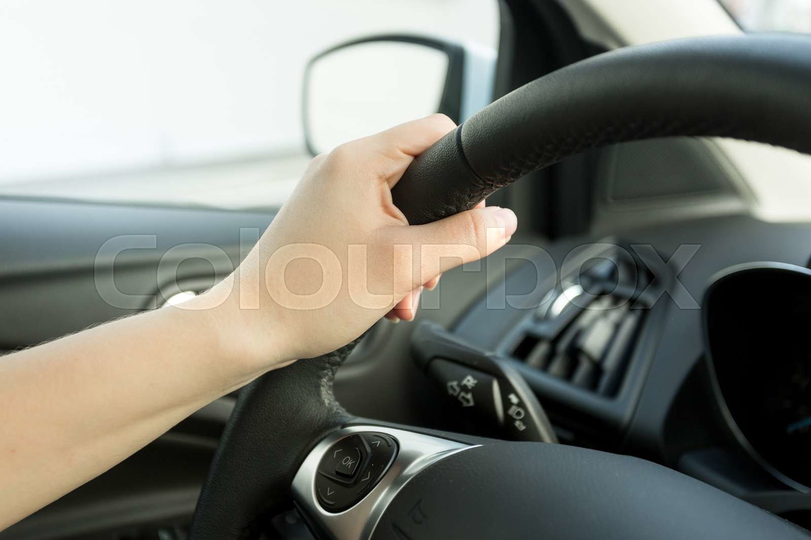 Closeup of female hand holding car steering wheel Stock image Colourbox