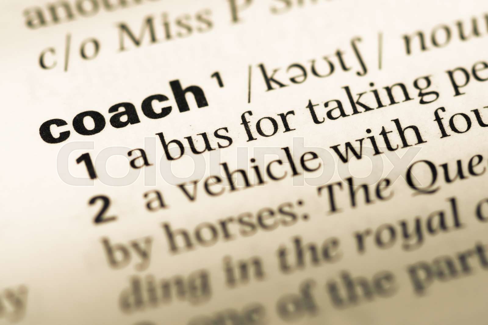 Close up of old English dictionary page with word coach. Stock image