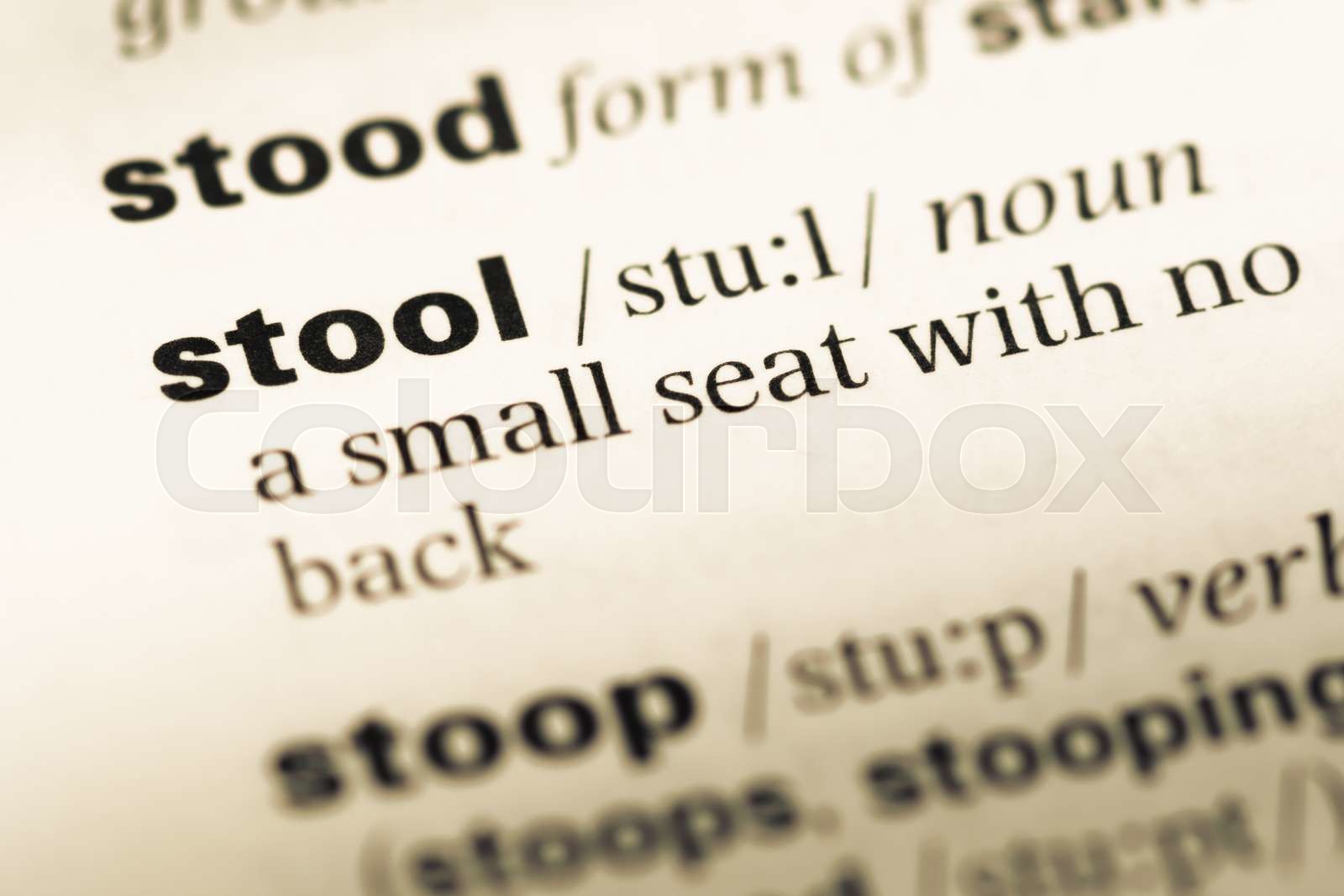 Close up of old English dictionary page with word stool. Stock image