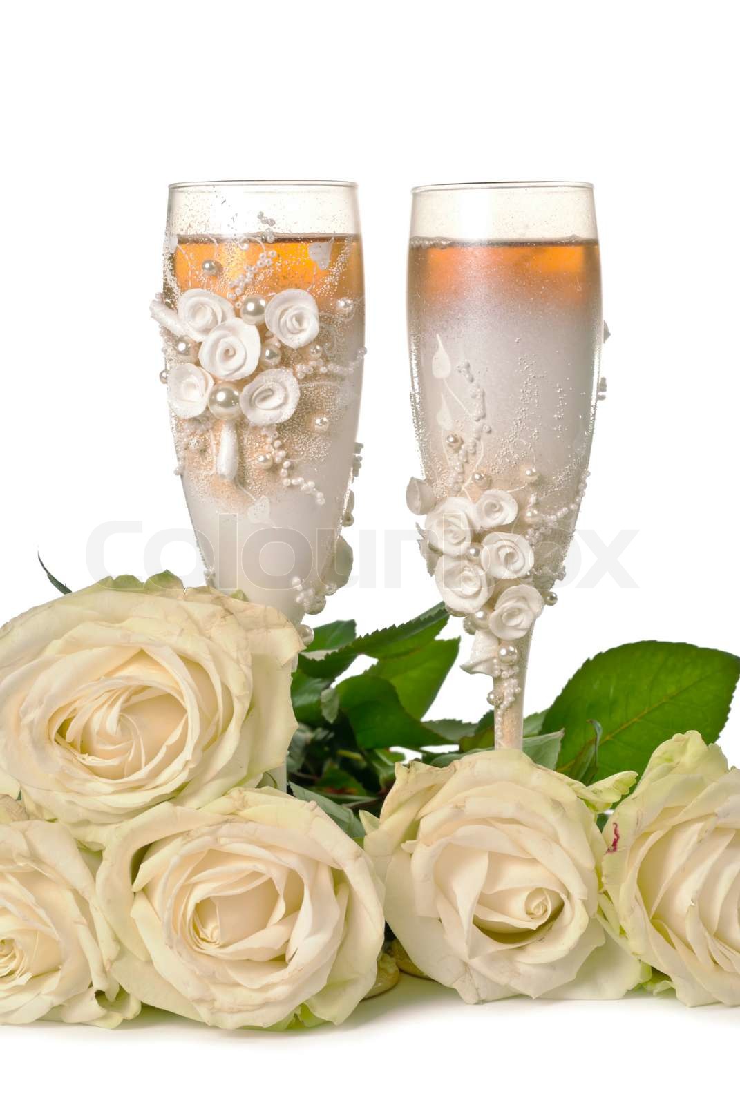Two glasses of celebratory champagne with white roses Stock image