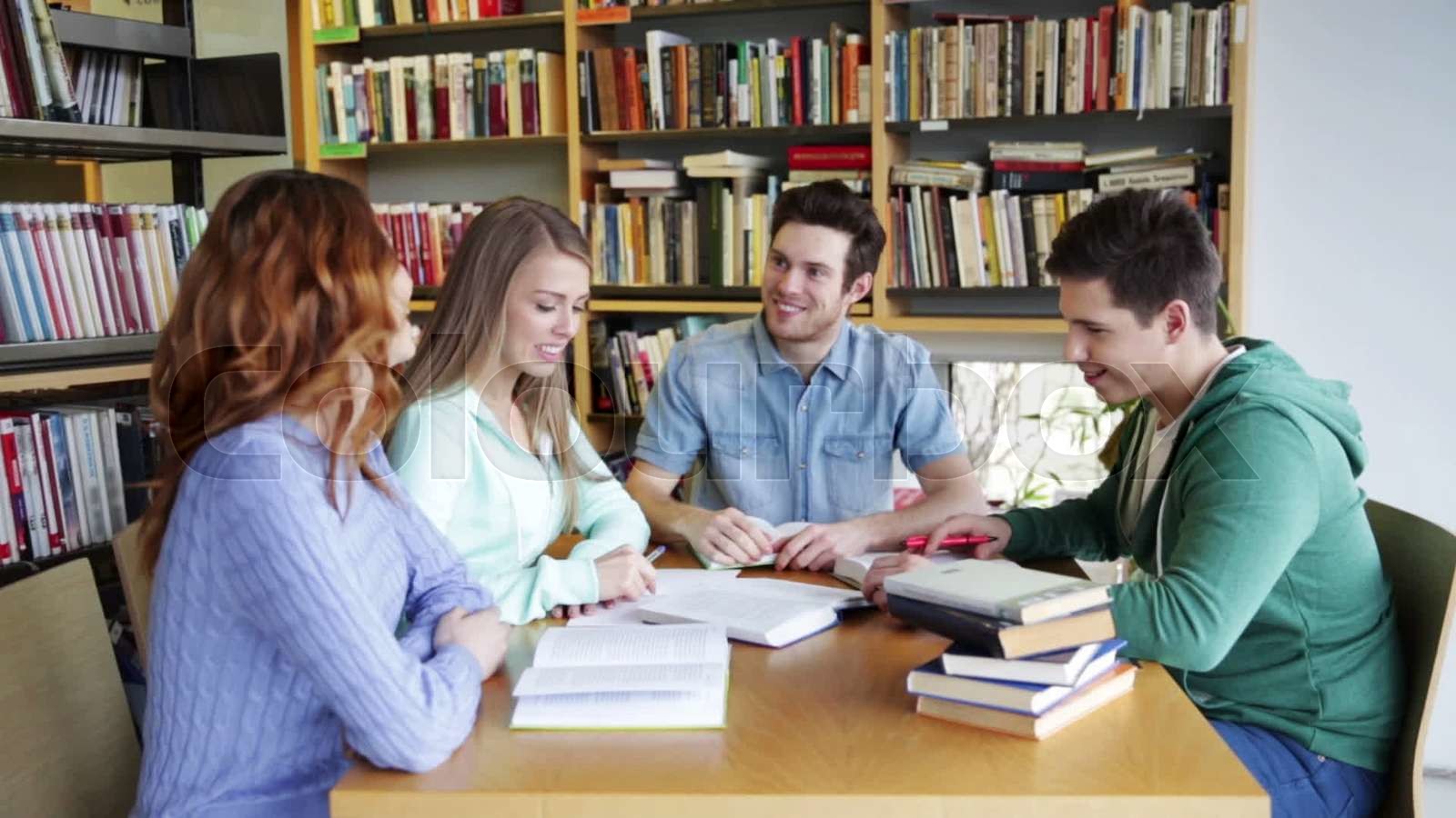 students with books preparing to exam in library Stock video Colourbox