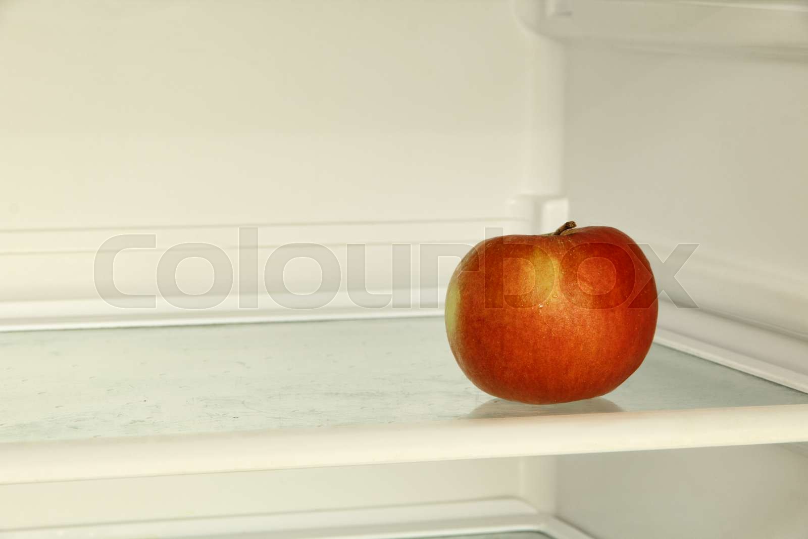 Ripe red apple in domestic refrigerator. Stock image Colourbox