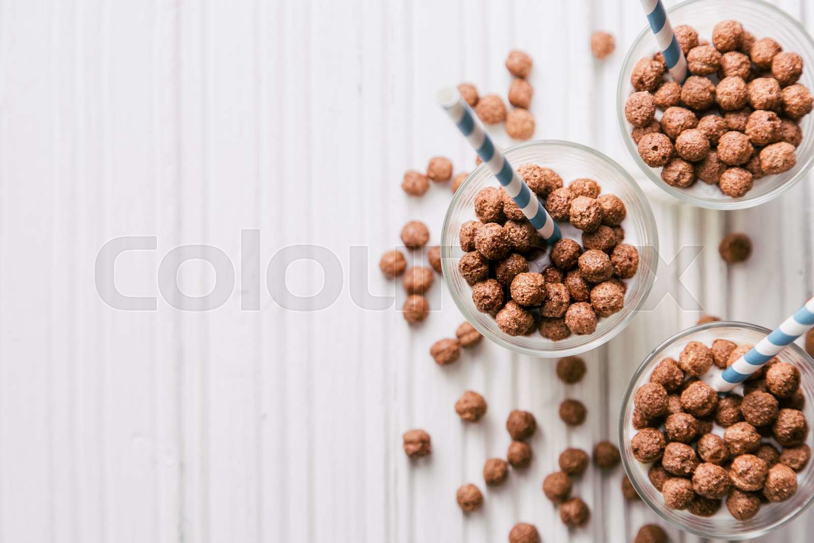 Chocolate cereal balls with milk and straws Stock image Colourbox