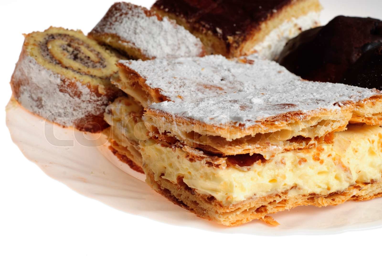Verschiedene Kuchen auf einem weißen Teller auf weißem Hintergrund ...