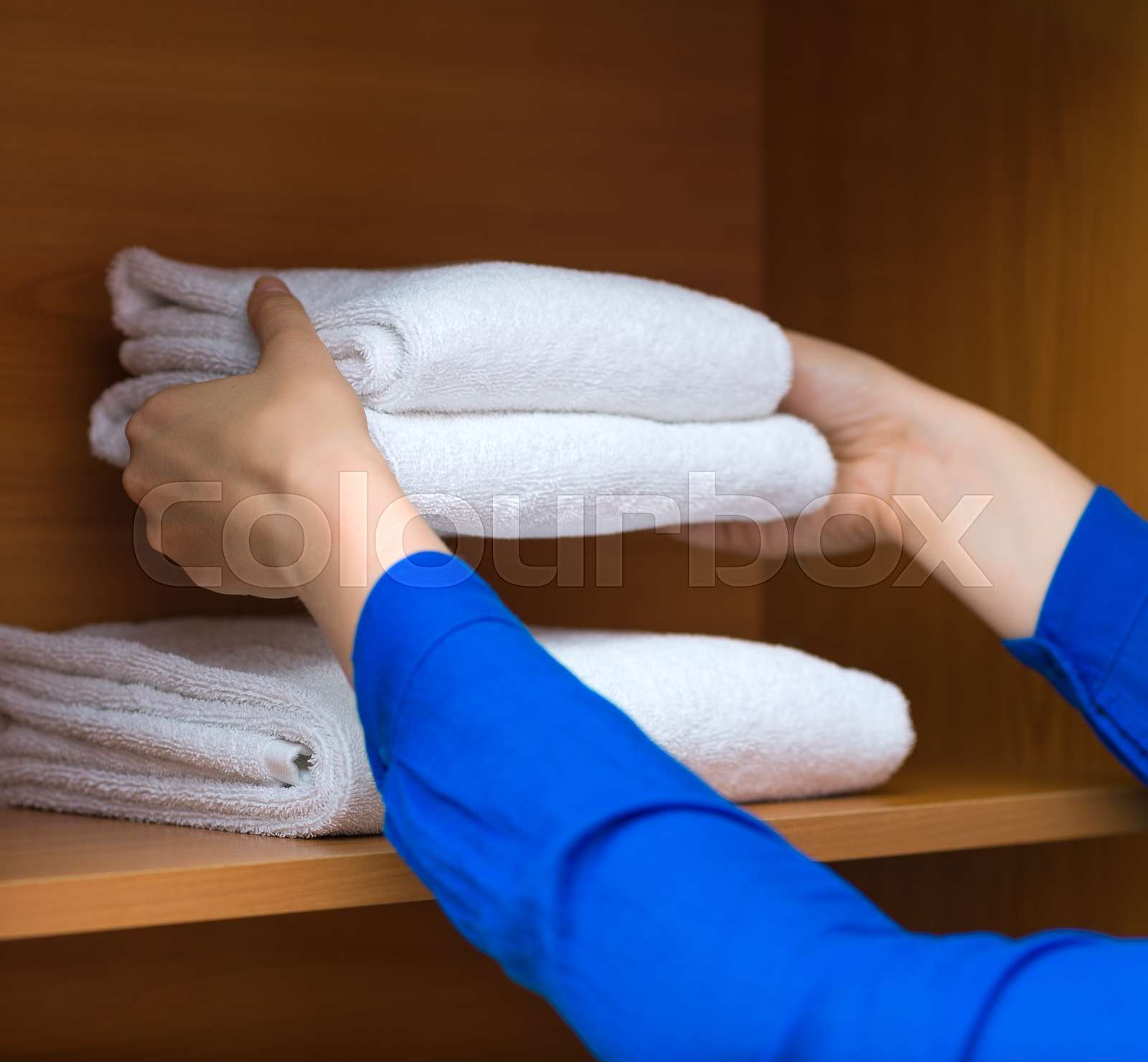 Room service. Woman changing towels in Stock image Colourbox