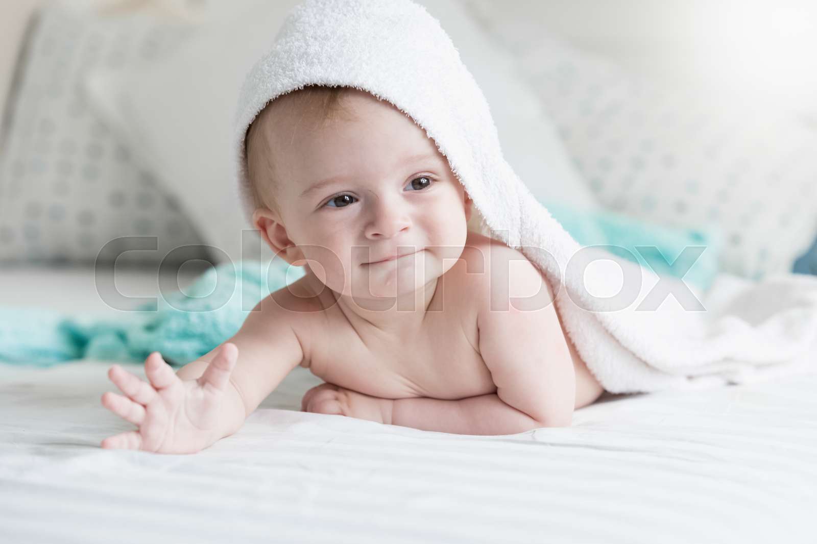 Happy 9 Months Baby Lying Under White Towel On Bed Stock Image 