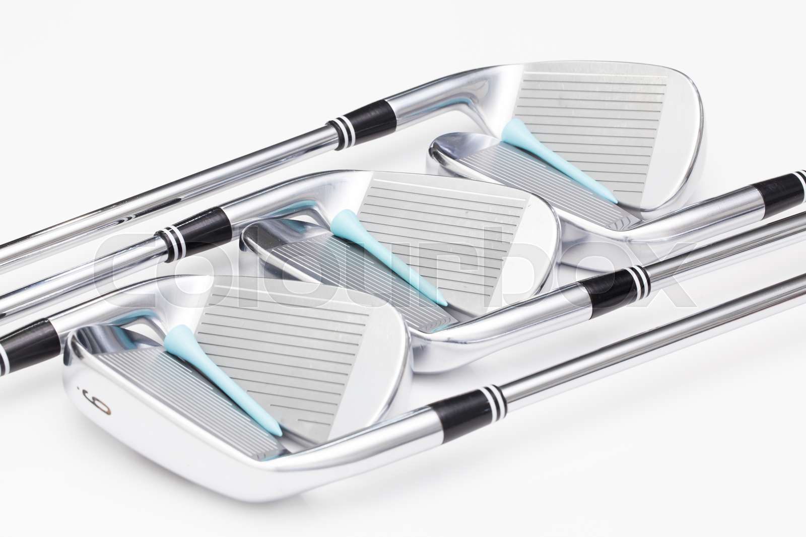 Titanium golf clubs on the white table Stock image Colourbox