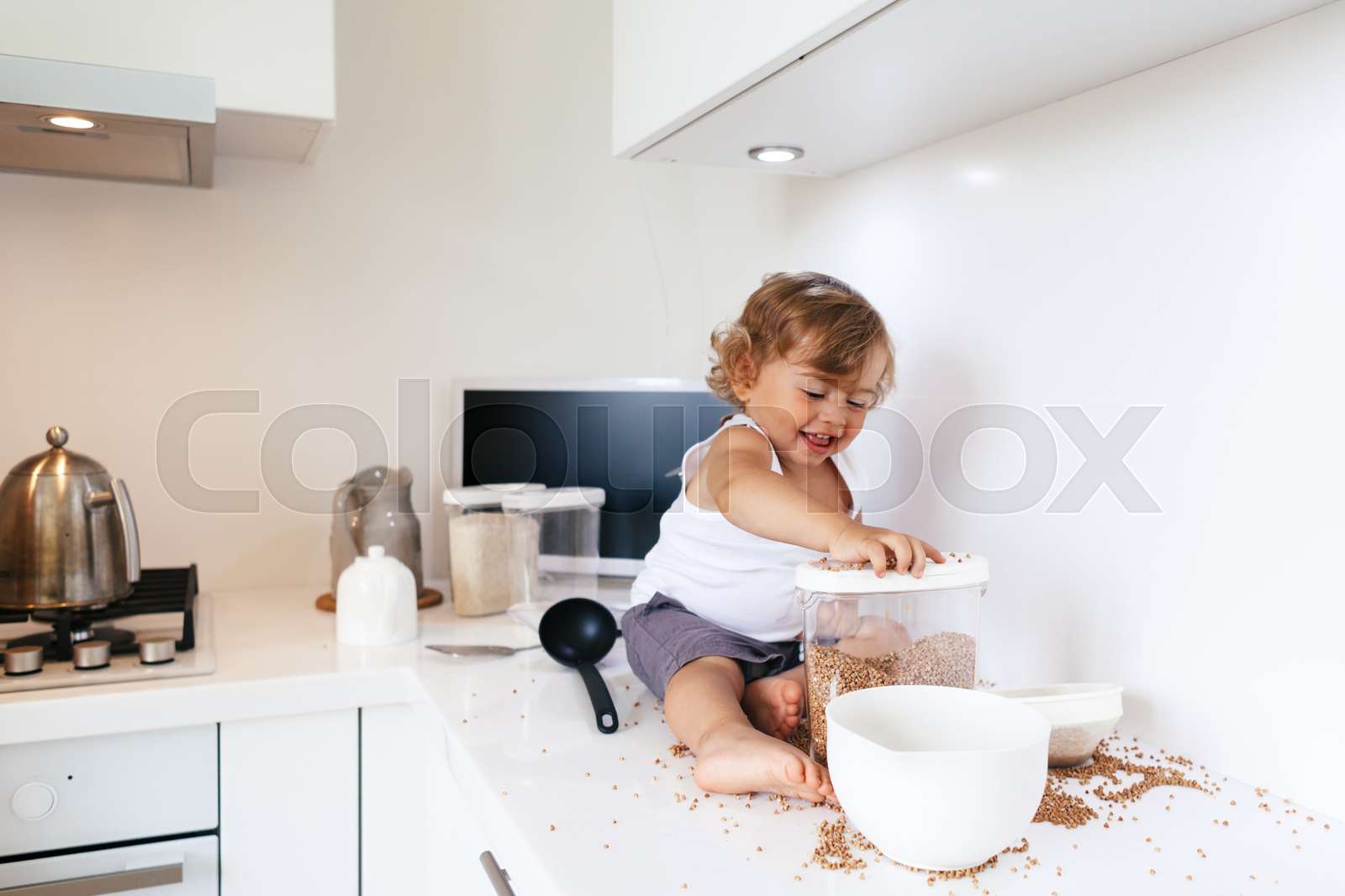Toddler playing at the kitchen | Stock image | Colourbox