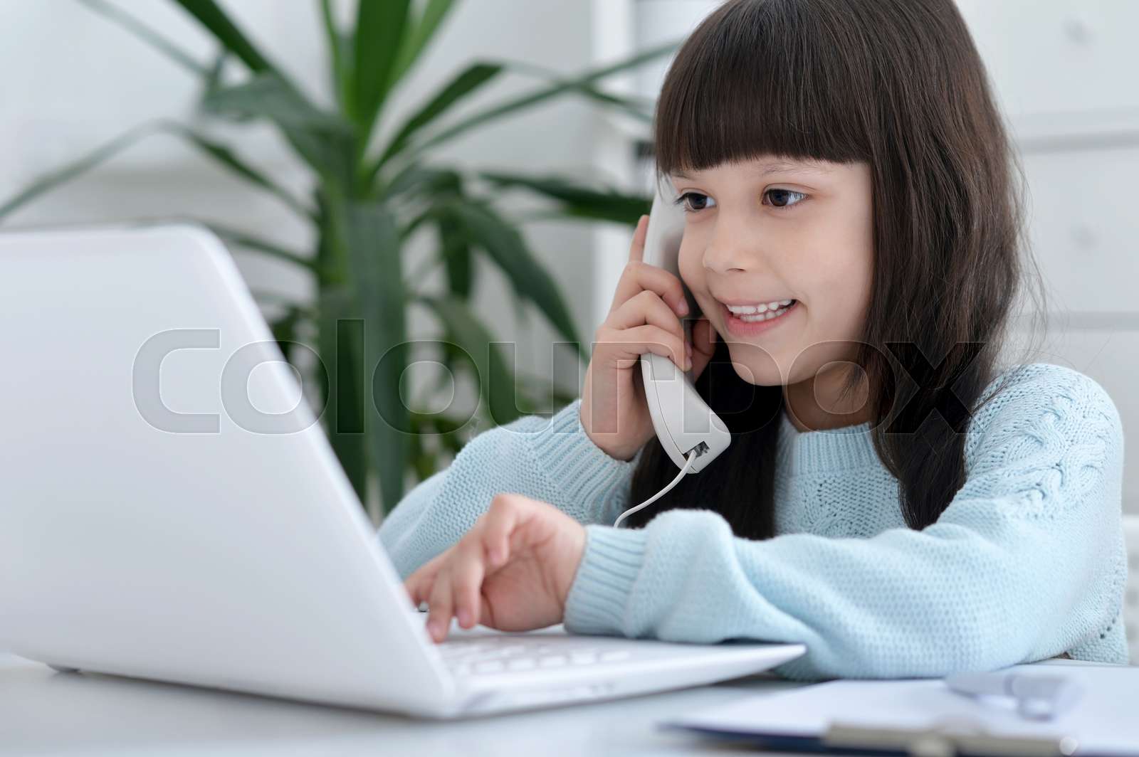 Little girl using computer | Stock image | Colourbox