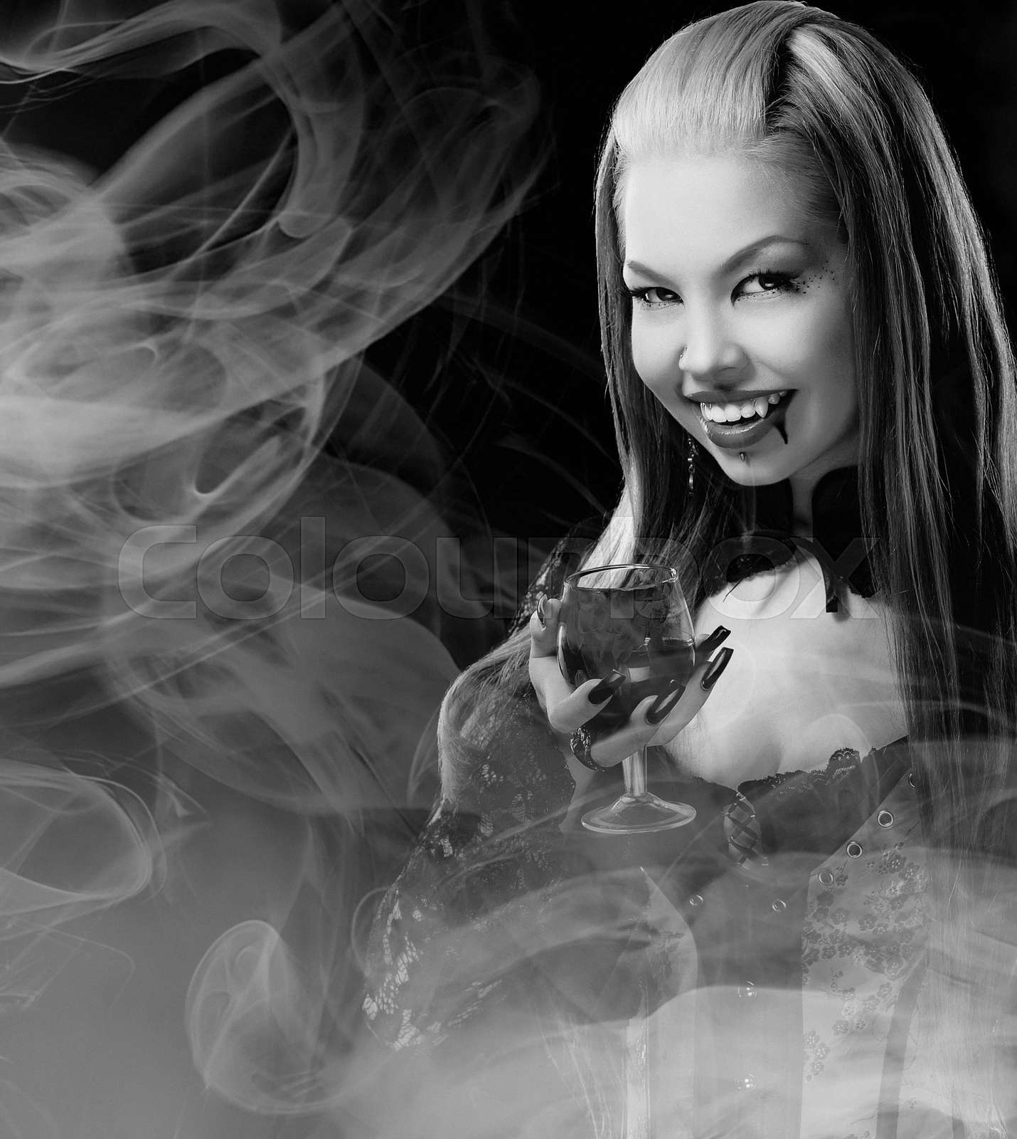 Portrait of redheaded gothic girl with glass Stock image Colourbox