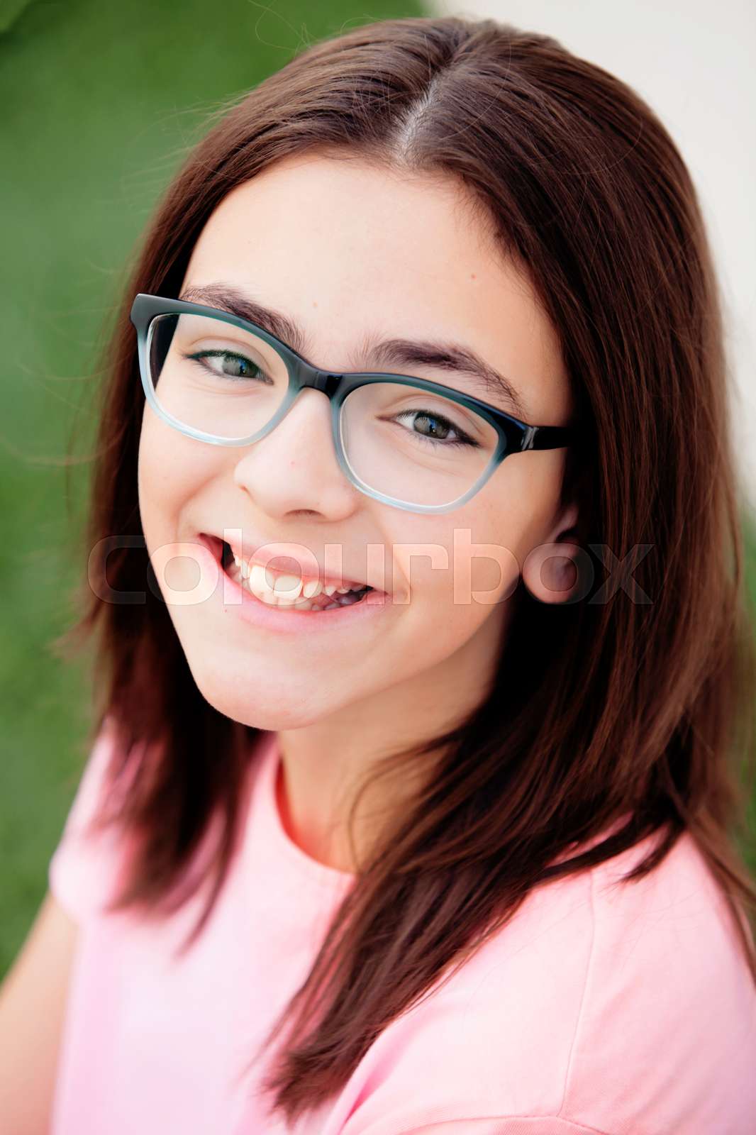 Pretty preteenager girl with glasses outside | Stock image | Colourbox
