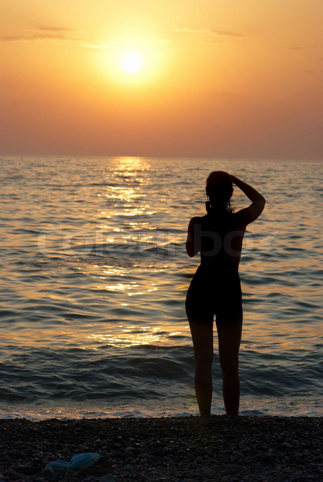 Girl silhouette and sunset on the sea | Stock image | Colourbox