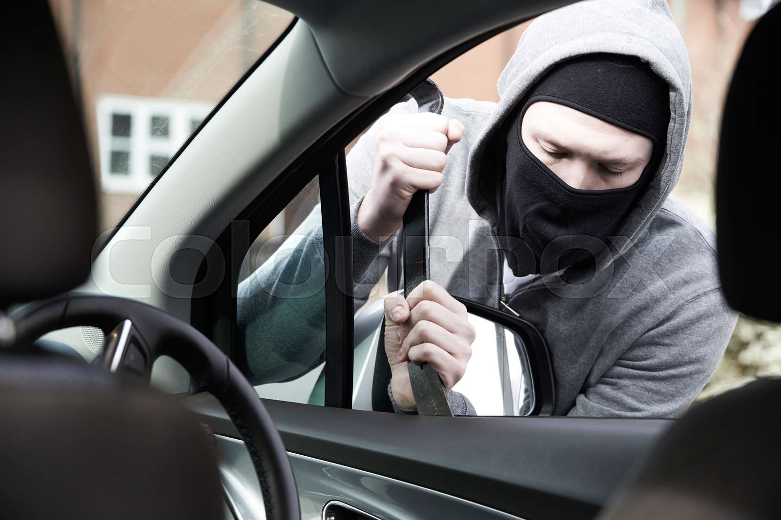 Masked Man Breaking Into Car With Crowbar | Stock image | Colourbox
