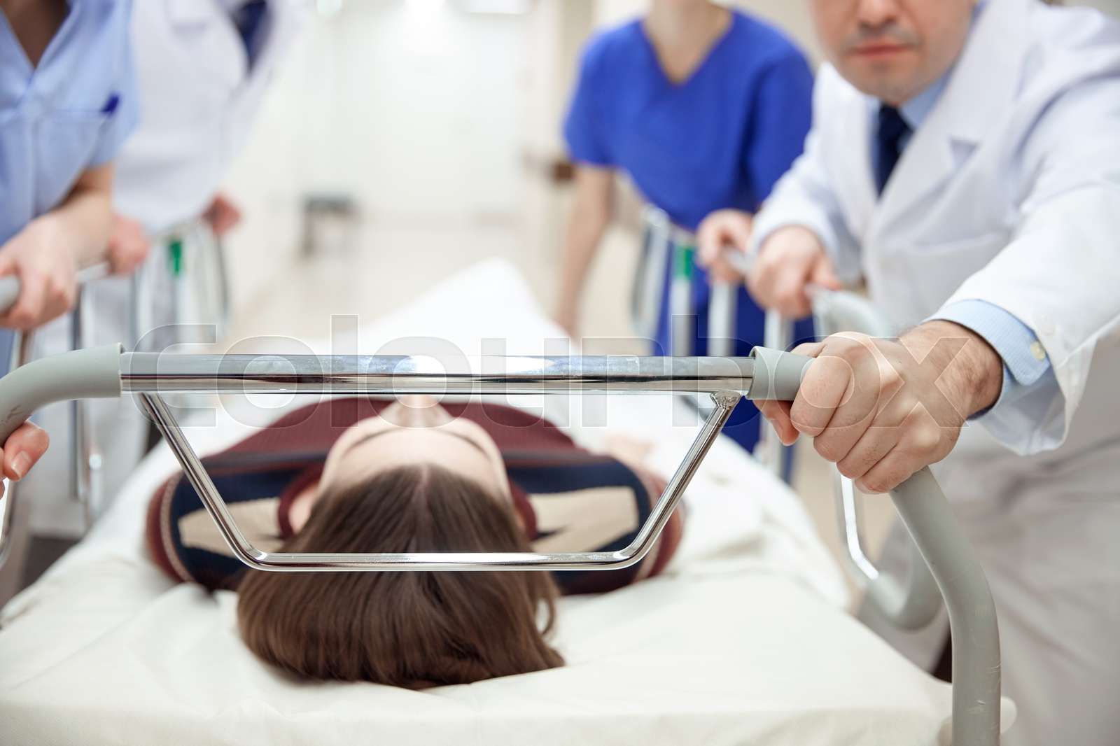 medics and patient on hospital gurney at emergency Stock image