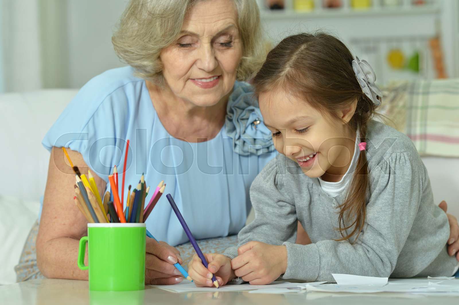 Grandmother with granddaughter drawing together Stock image Colourbox