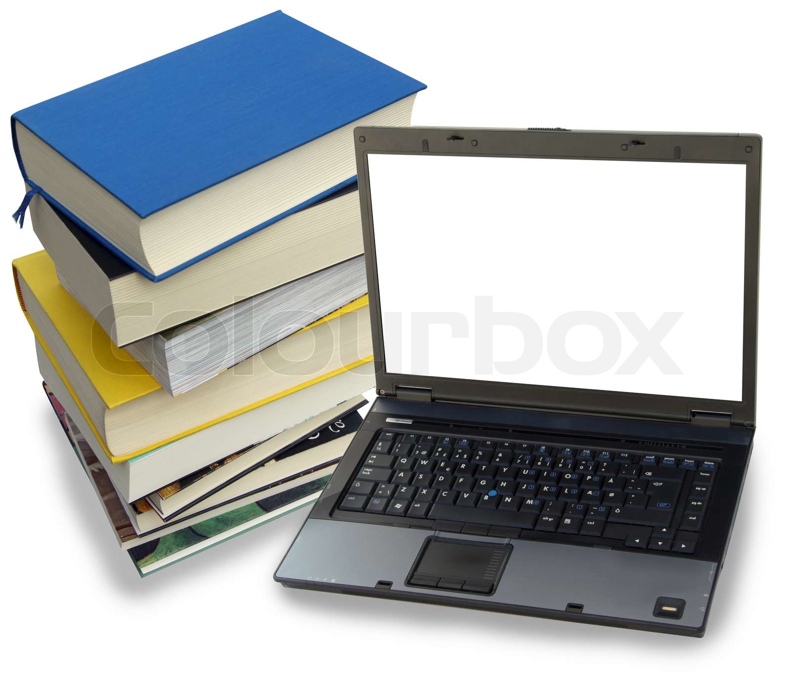 Pile of study books and a laptop computer with white screen for writing ...