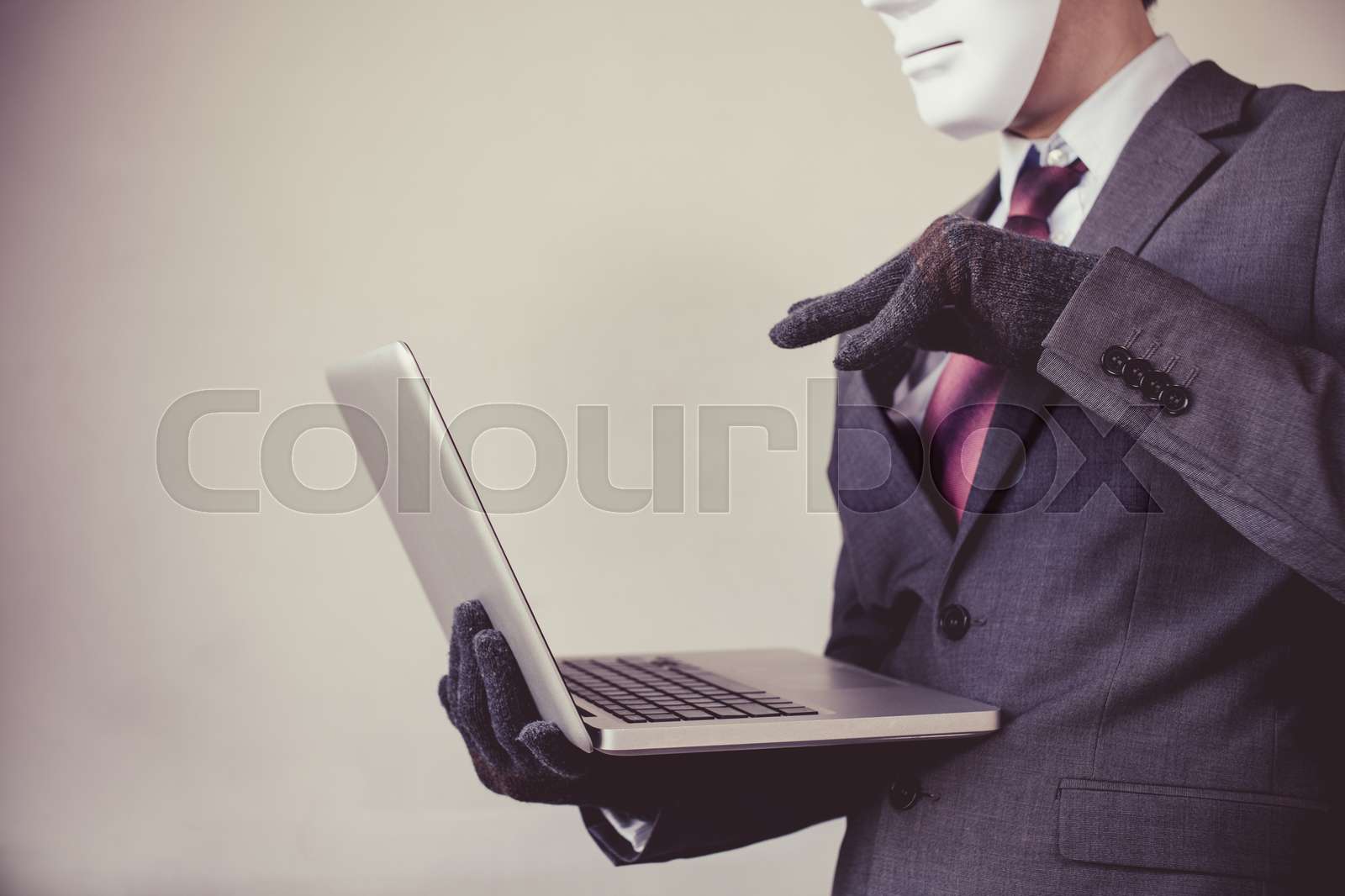 Business man in white mask wearing gloves and using computer fraud