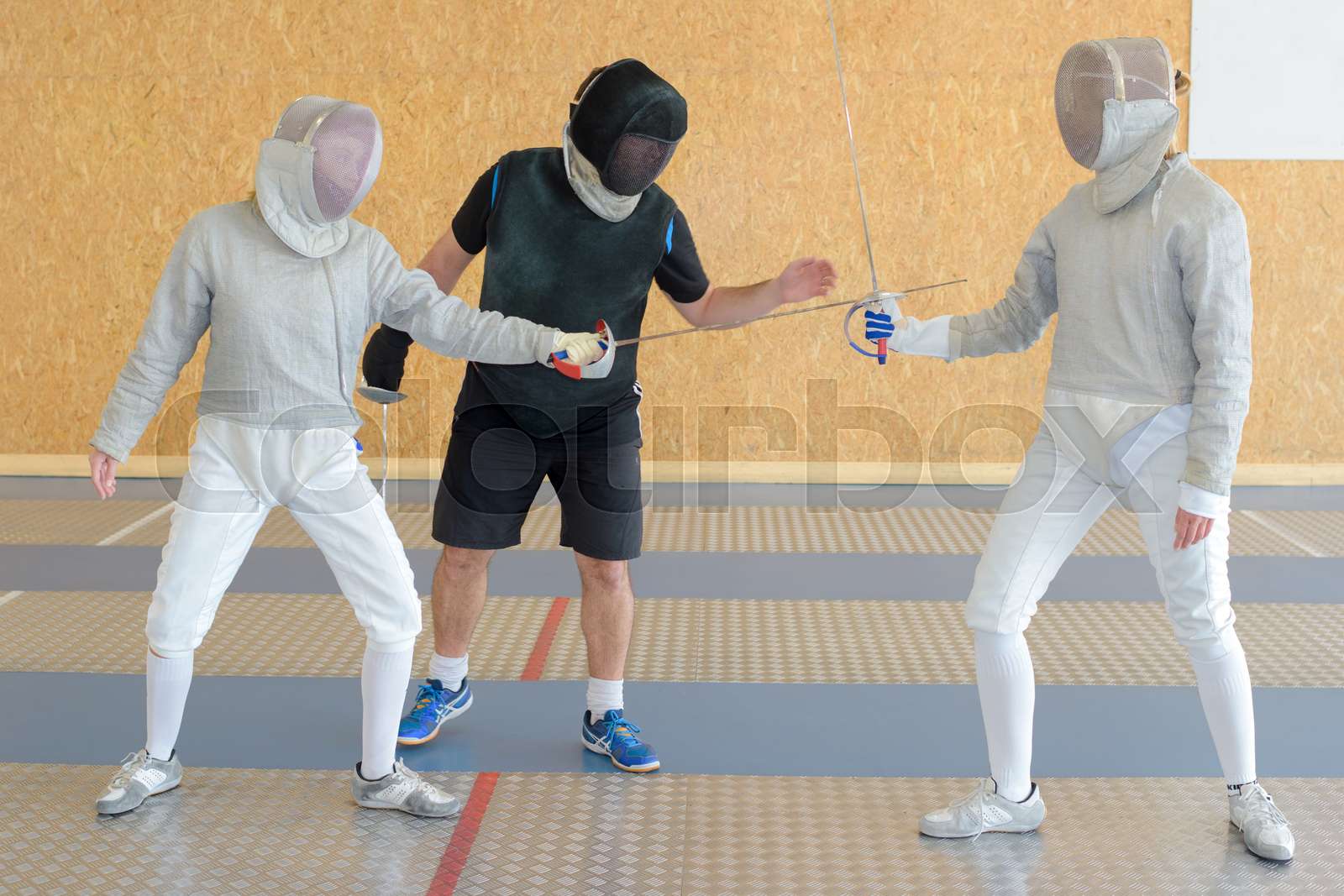 fencing practice with referee Stock image Colourbox