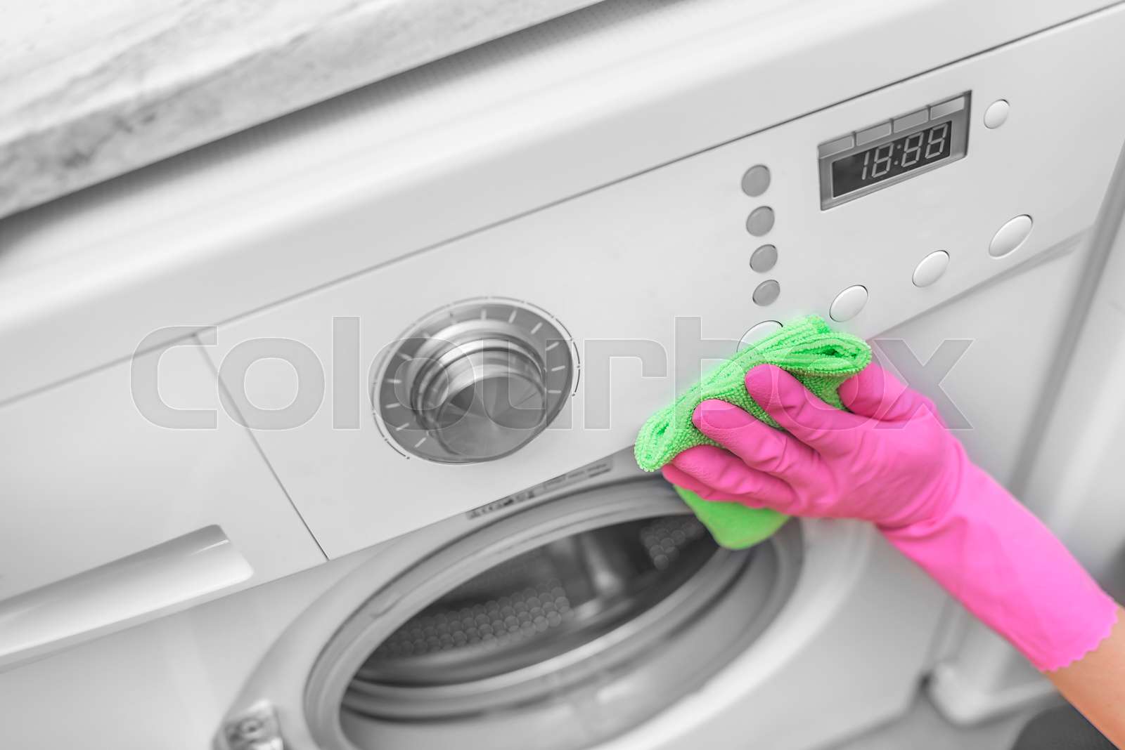 Female hand wash washing machine. Stock image Colourbox