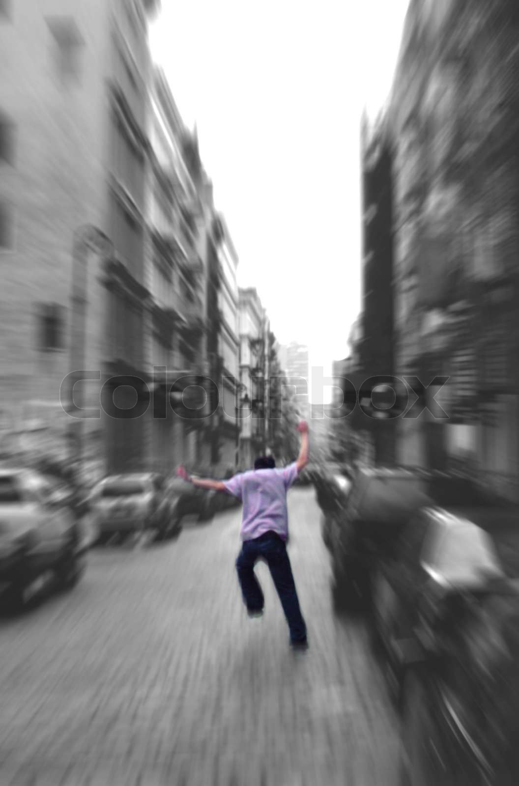 A man running away in the city | Stock image | Colourbox