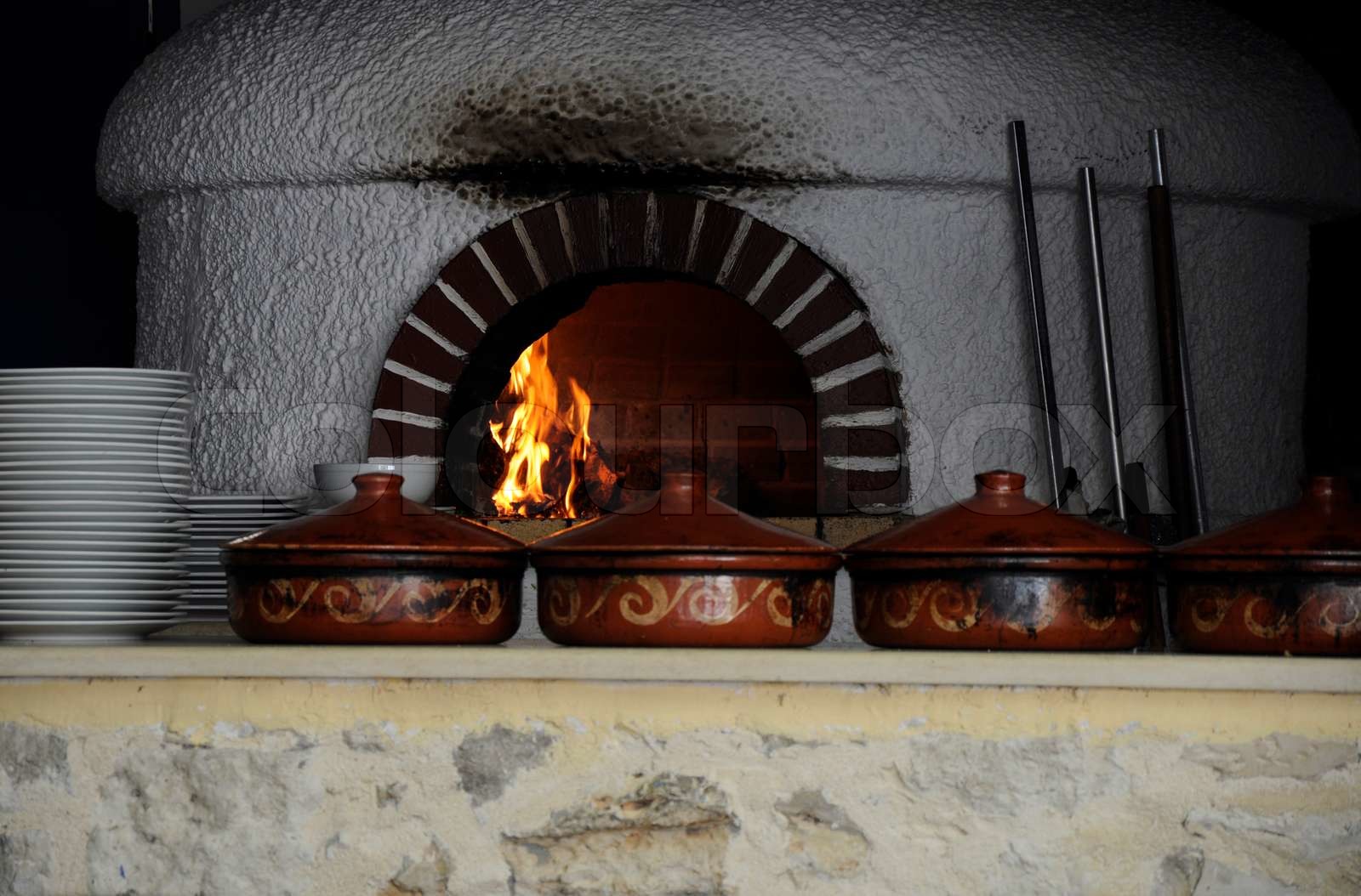 Ancient Greek cooking techniques involving open fire and stews