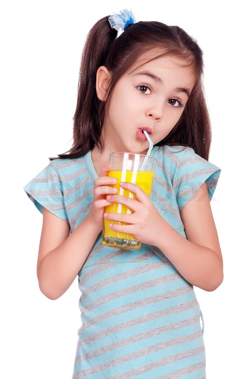 Portrait of happy little girl drinking orange juice | Stock image ...