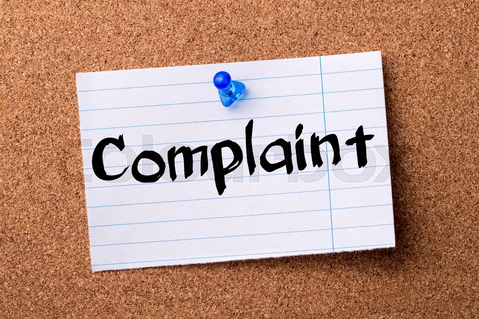 Complaint teared note paper pinned on bulletin board Stock image