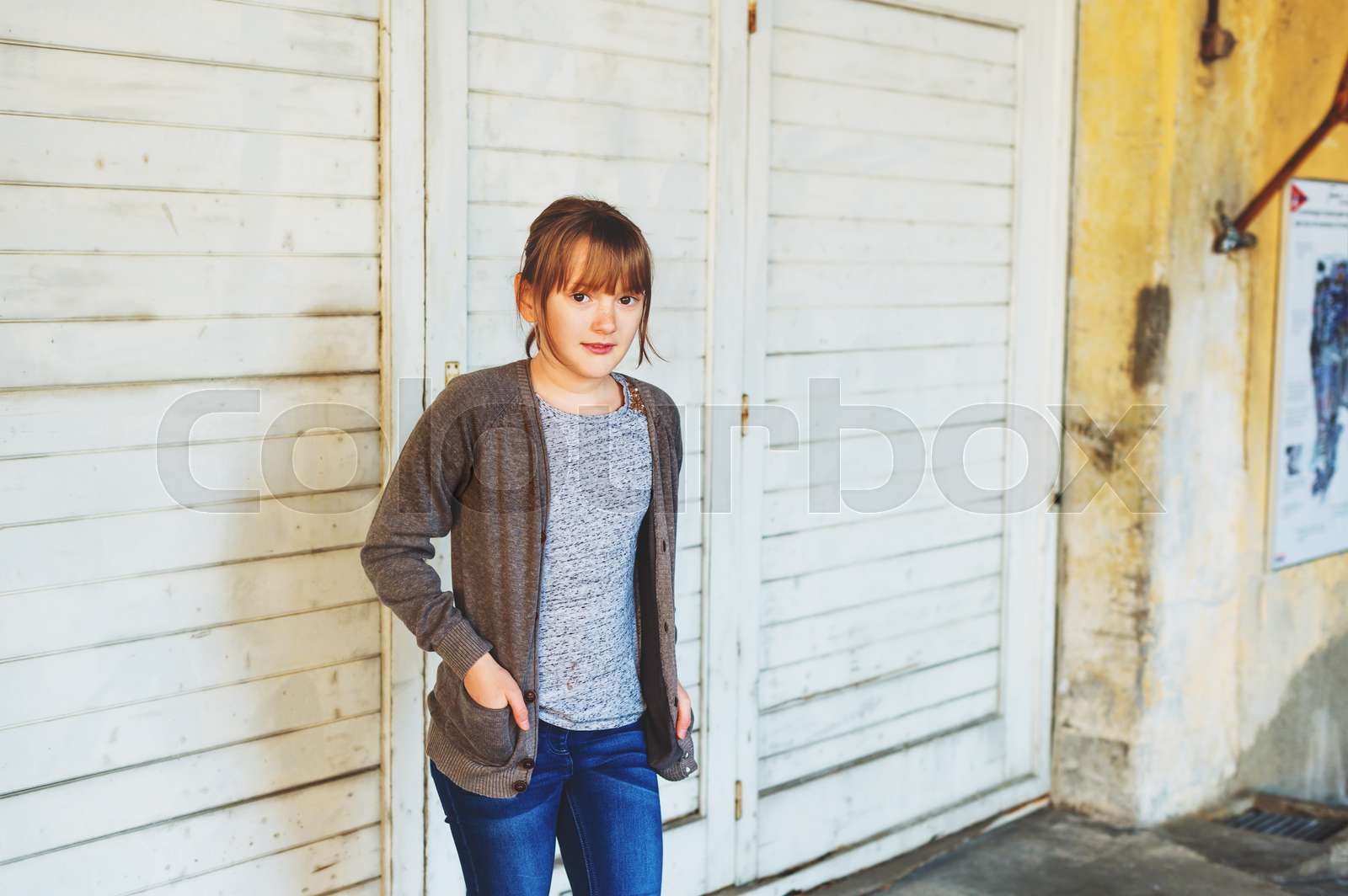 Outdoor Portrait Of Cute Little 9 Year Old Girl Wearing Grey Jacket