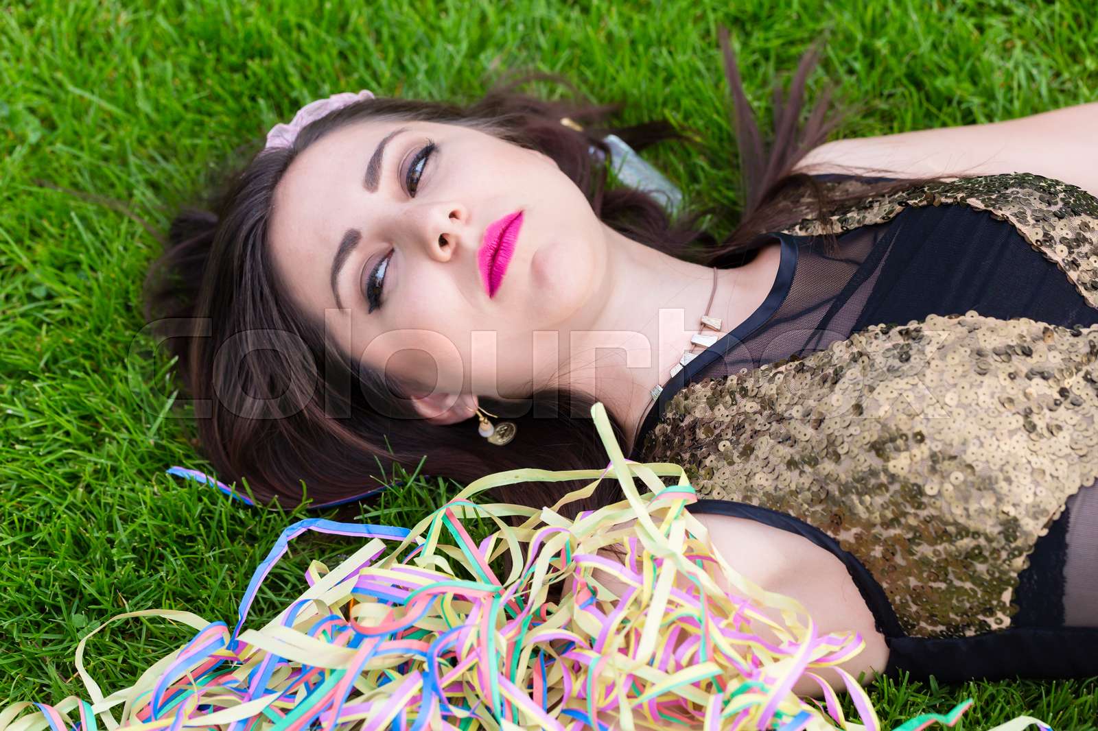 Drunk girl lying on the lawn after bachelorette party | Stock image