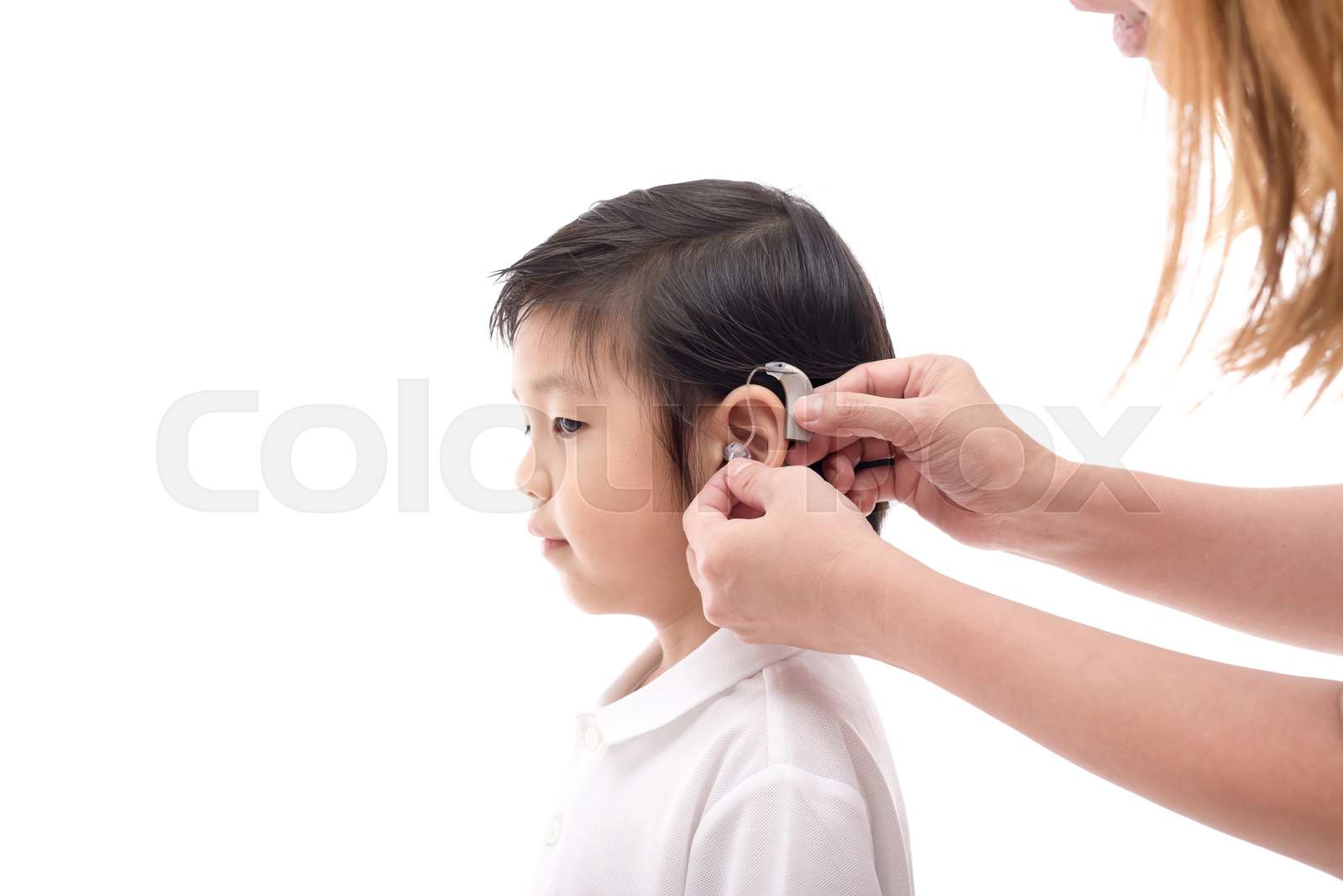 Doctor Inserting Hearing Aid Stock image Colourbox