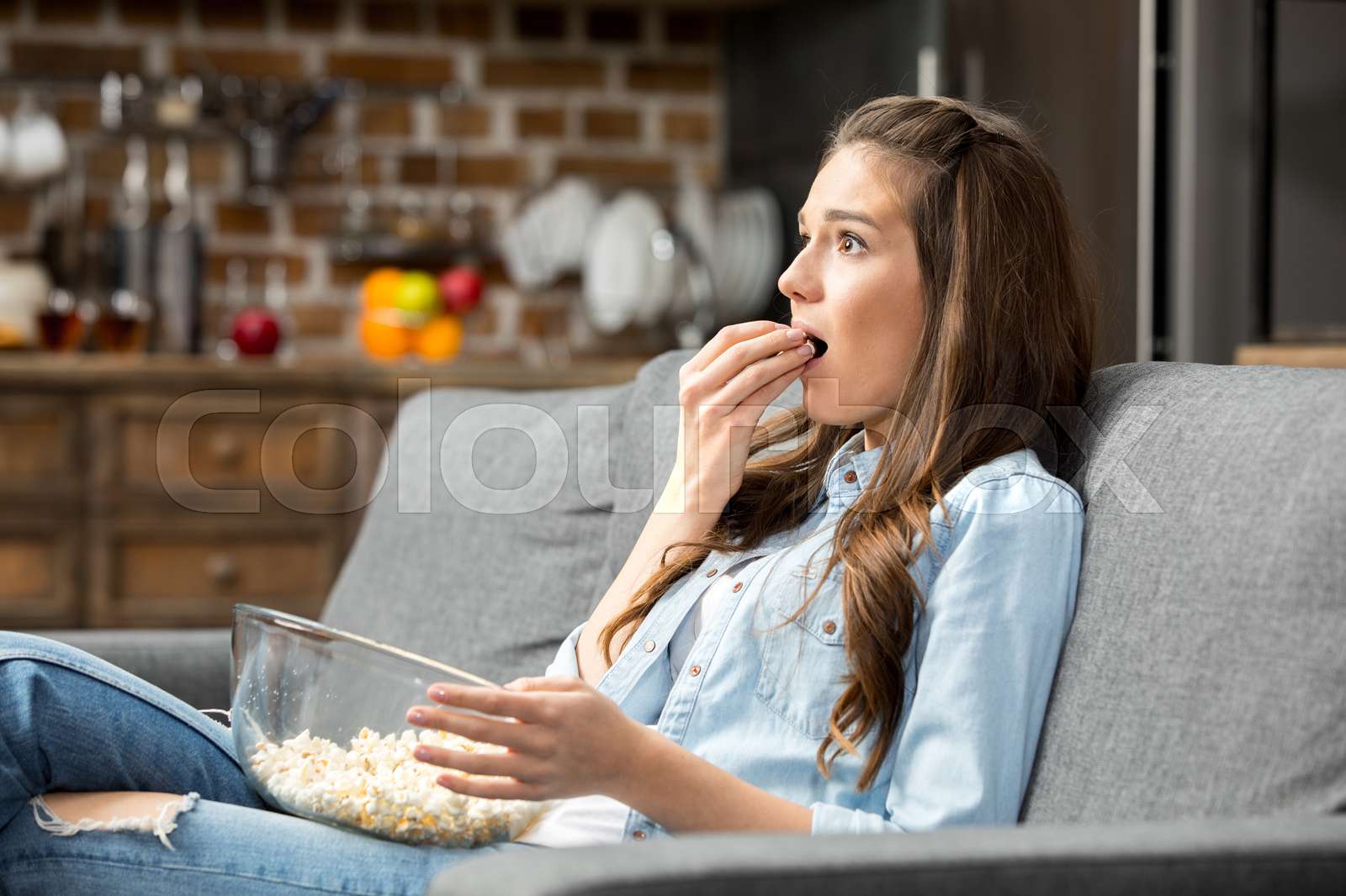 Girl eating popcorn Stock image Colourbox