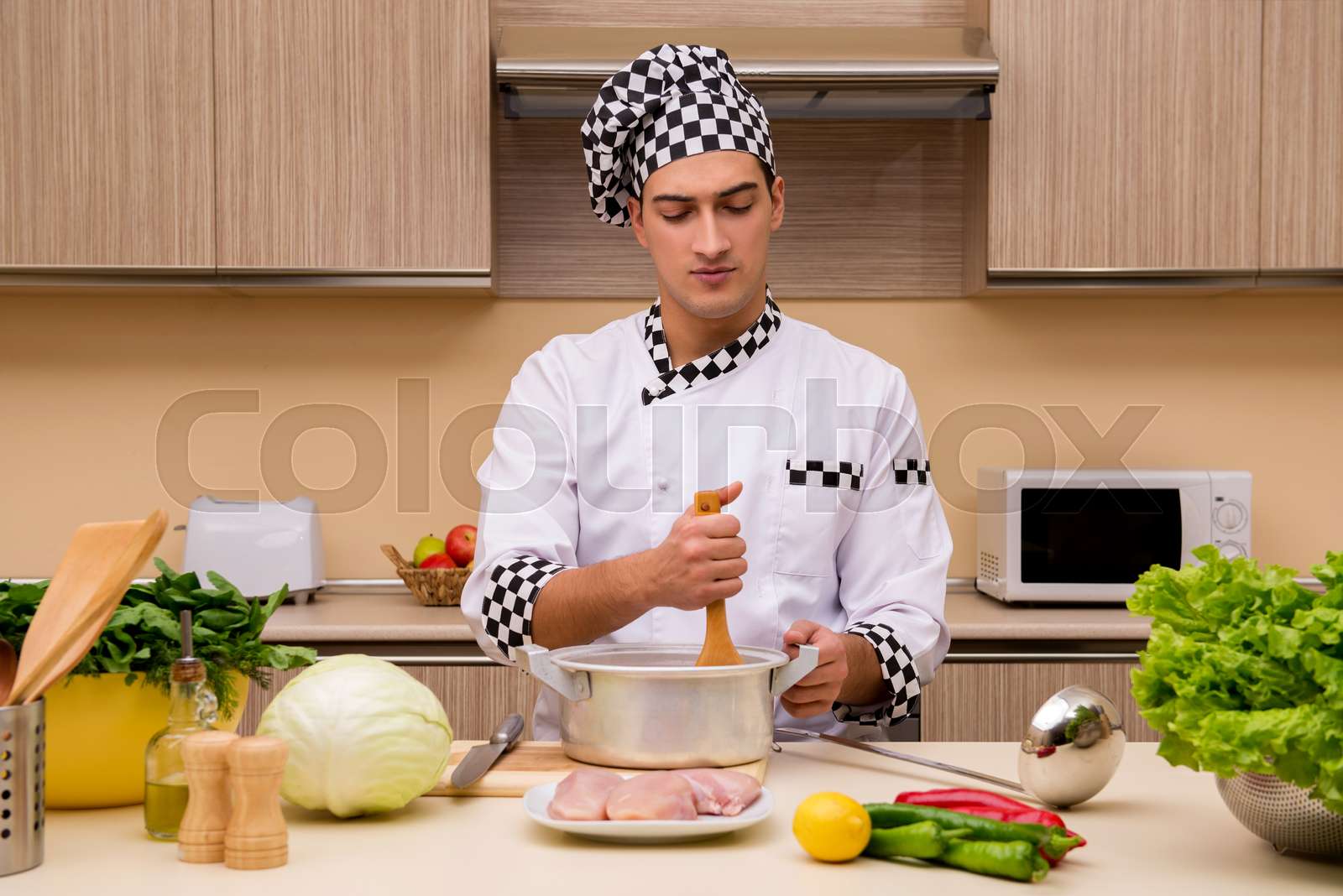 Young chef working in the kitchen | Stock image | Colourbox
