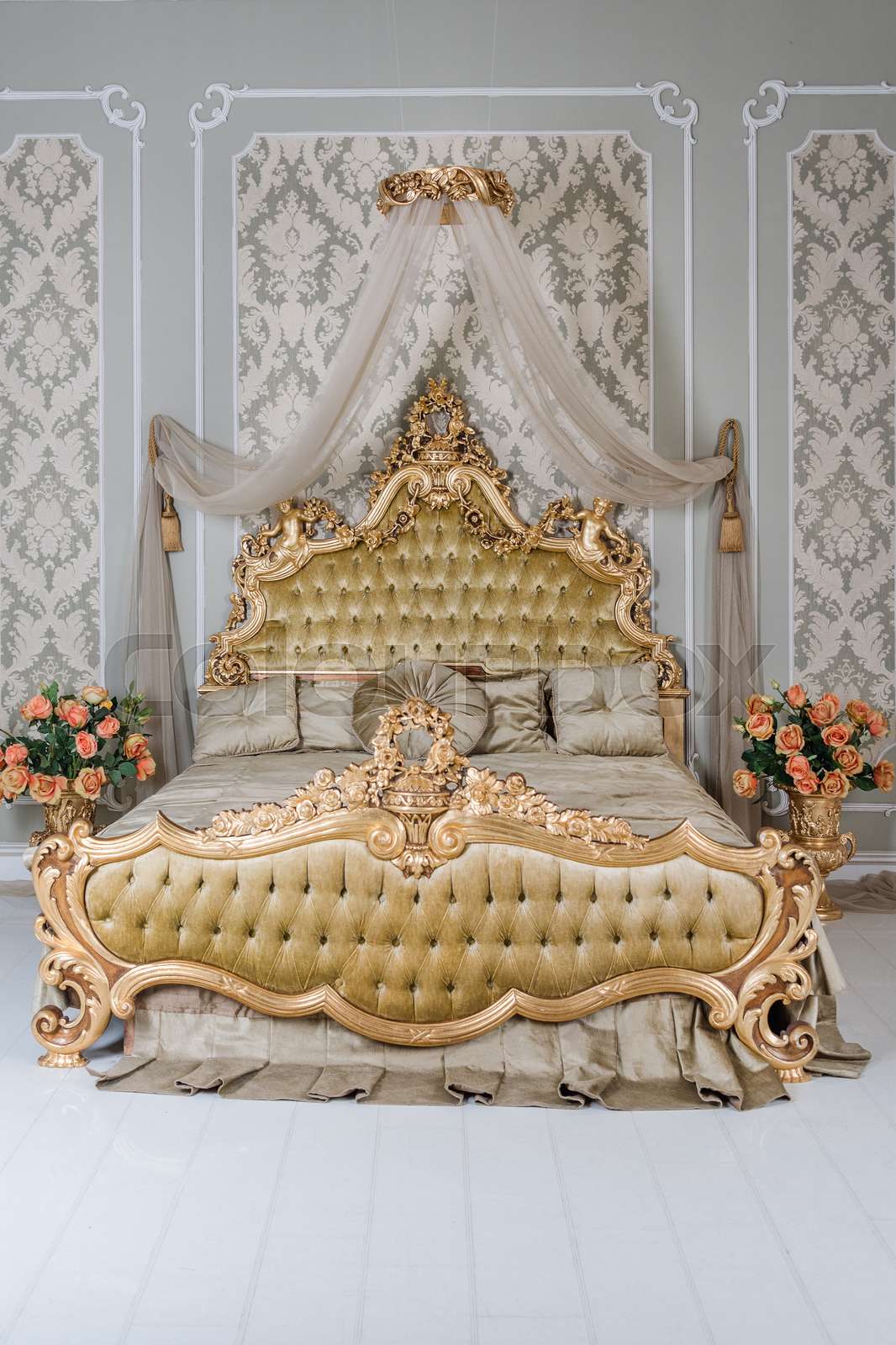 Luxury bedroom in light colors with golden furniture details. Big ...