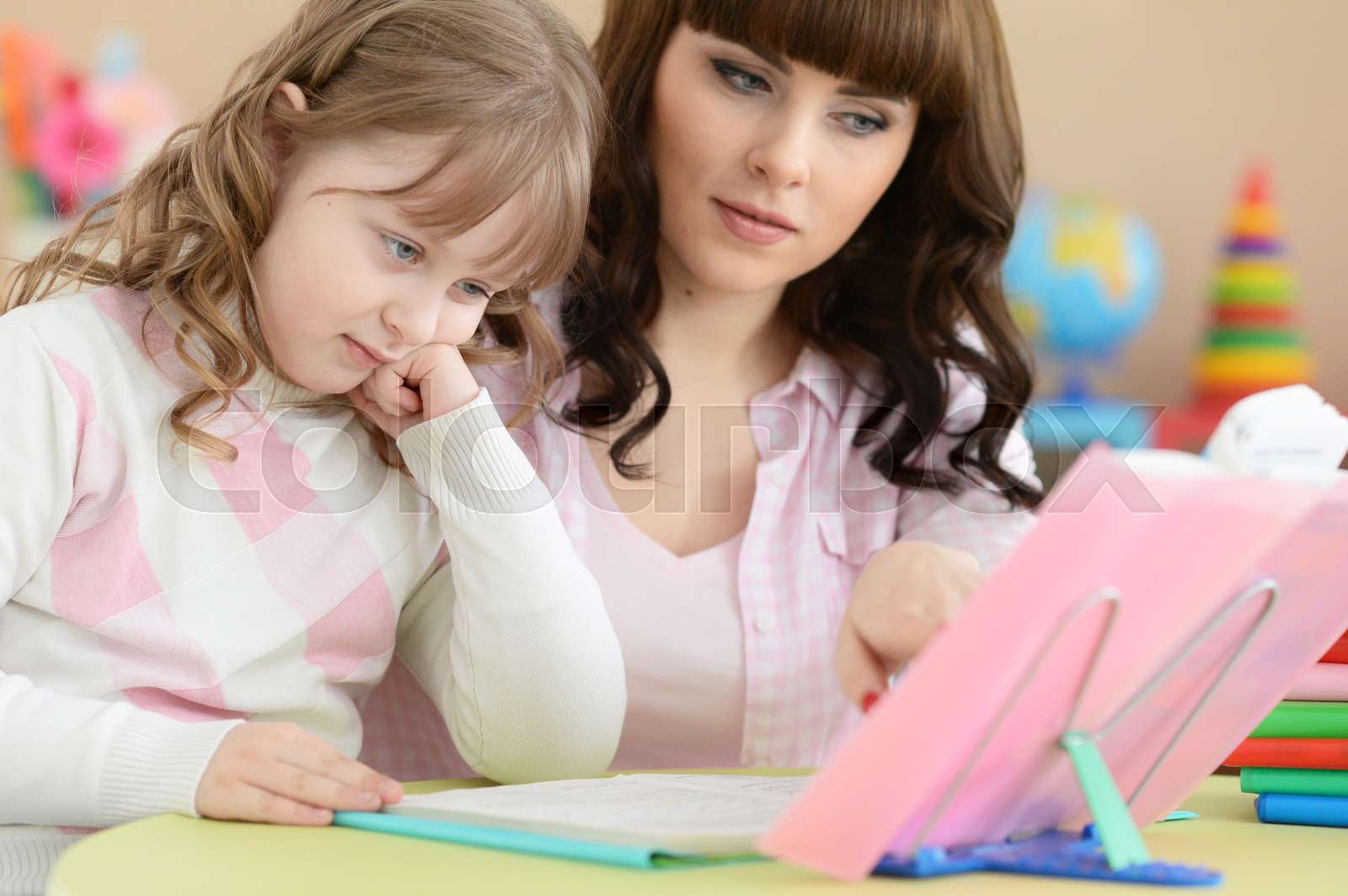 Mother and daughter doing lessons Stock image Colourbox
