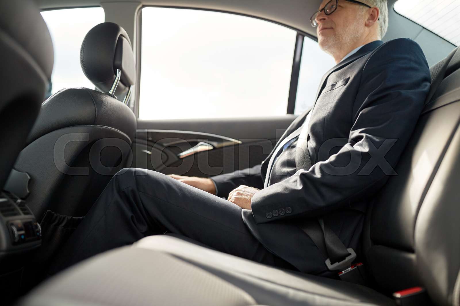 senior businessman driving on car back seat Stock image Colourbox