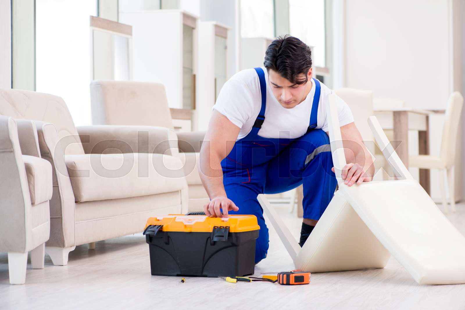 Furniture repairman working in store Stock image Colourbox