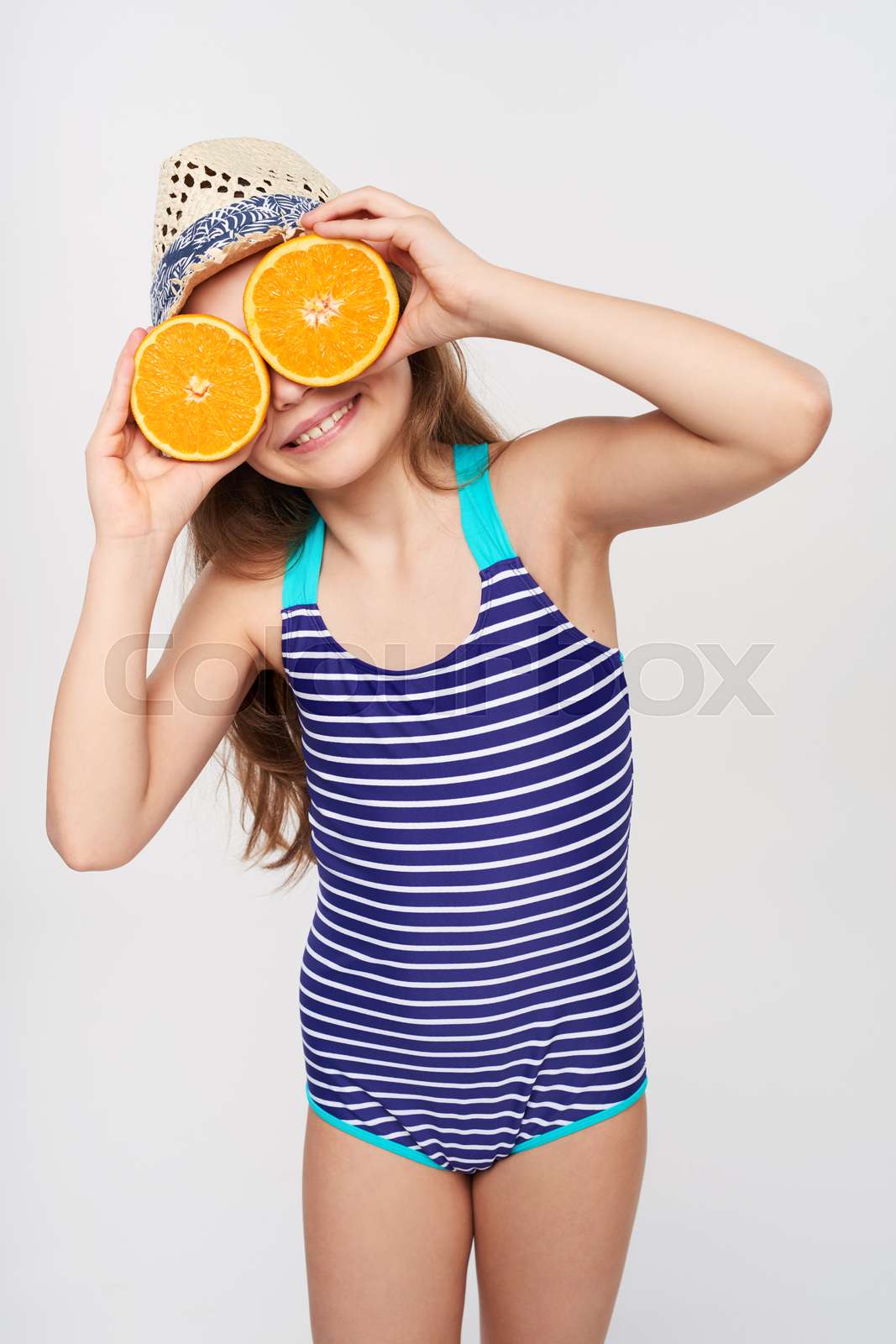 Girl in swimsuit with a lot of citrus fruits | Stock image | Colourbox