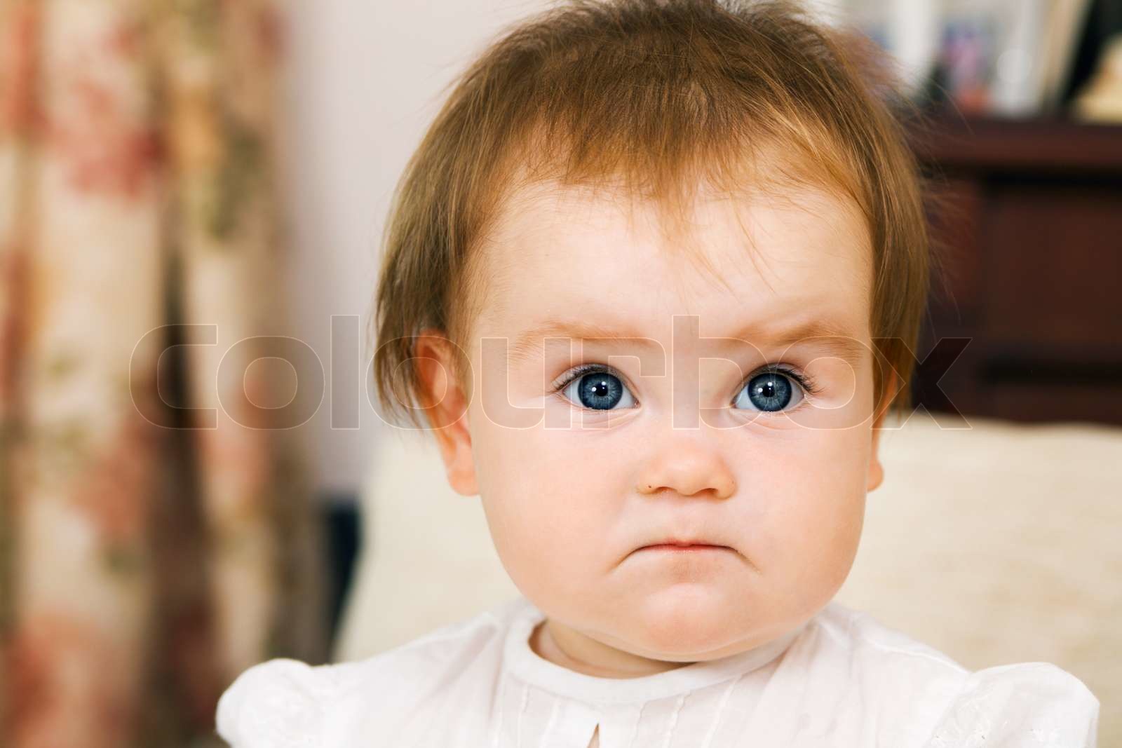 Cute little girl is frowning, face portrait | Stock image | Colourbox