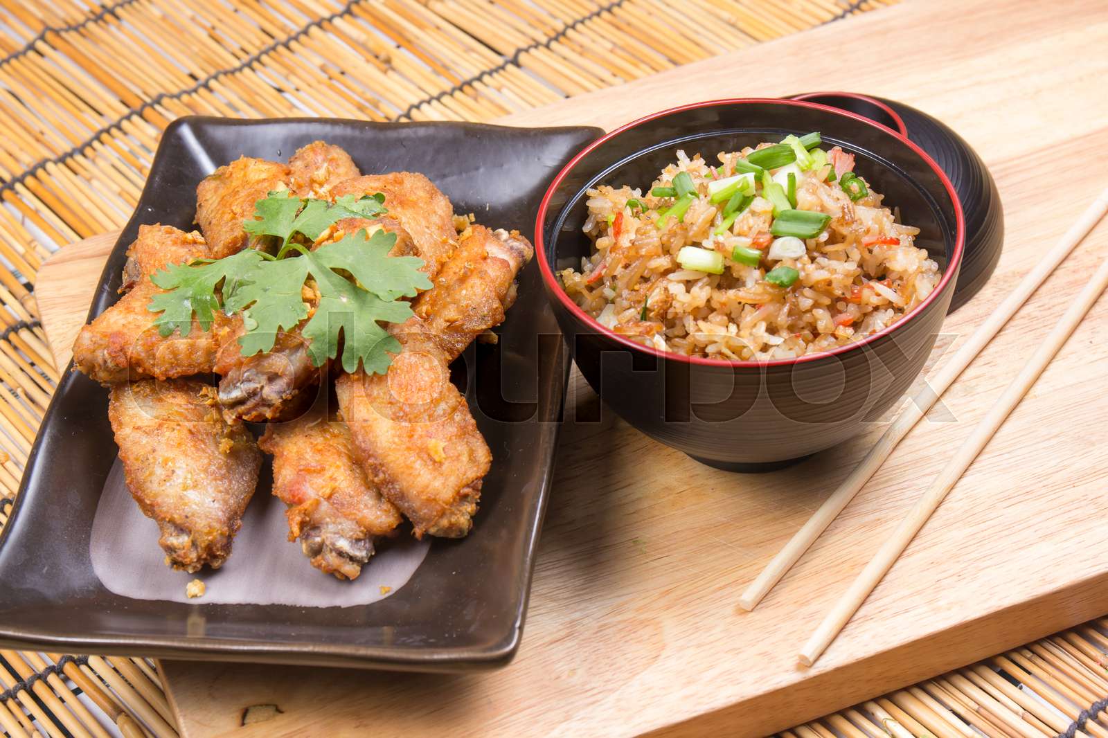 Fried chicken wings served with fry rice | Stock image | Colourbox