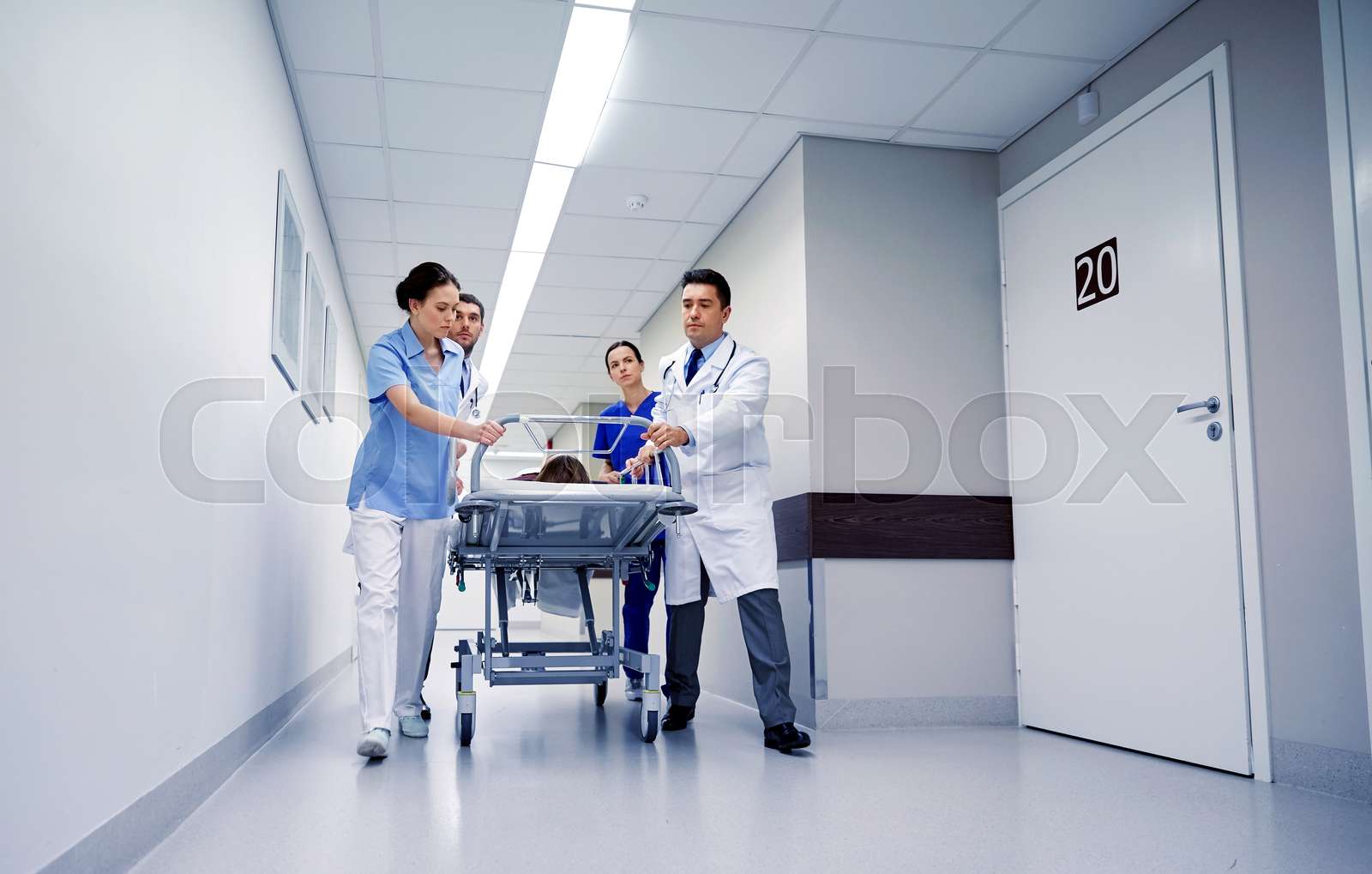 medics and patient on hospital gurney at emergency Stock image