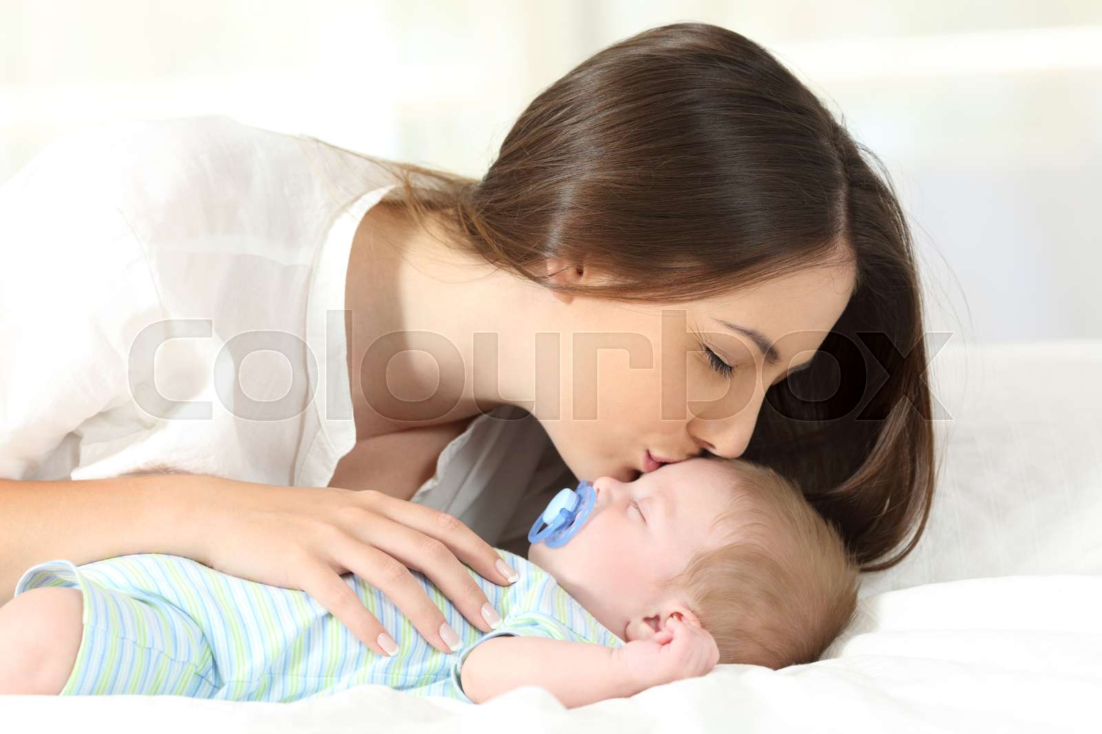 Affectionate Mother Kissing Her Baby Sleeping Stock Image Colourbox