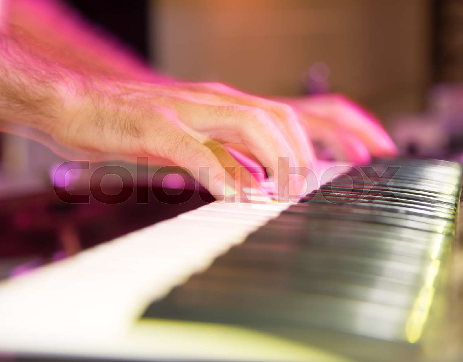 Musician plays keyboards in a rock band | Stock image | Colourbox