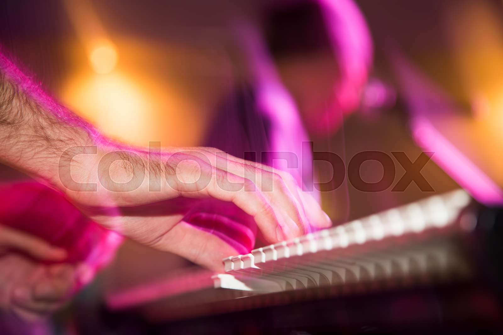 Musician plays keyboards in a rock band | Stock image | Colourbox
