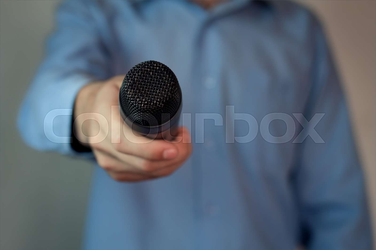 Interview with microphone. Stock image Colourbox