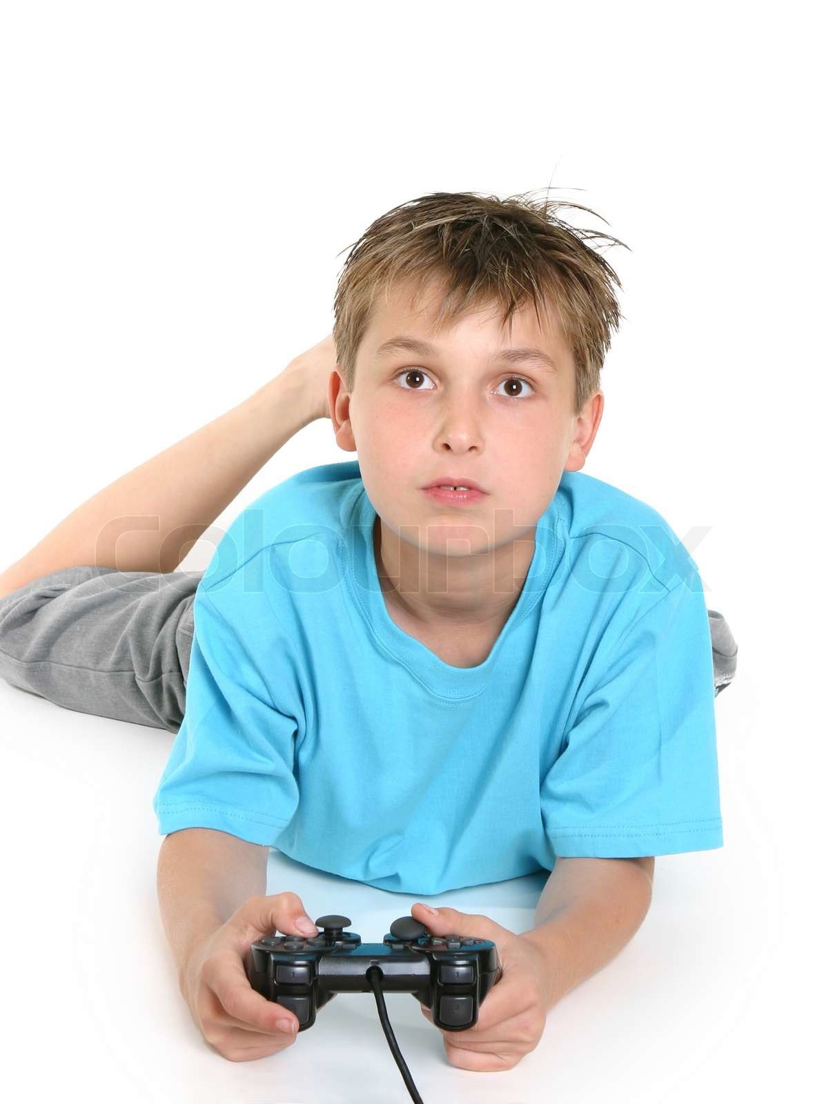 A boy on the floor playing a computer game | Stock image | Colourbox