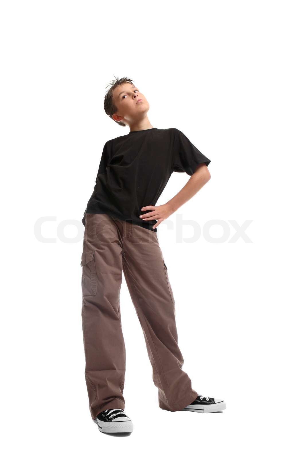 Standing boy in a plainblack t-shirt and cargosHe is looking sideways