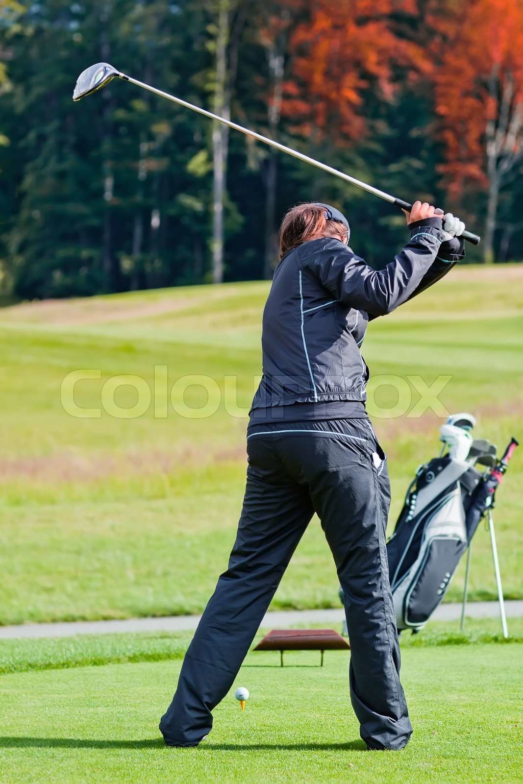 Young girl swinging golf club, rear view Stock image Colourbox
