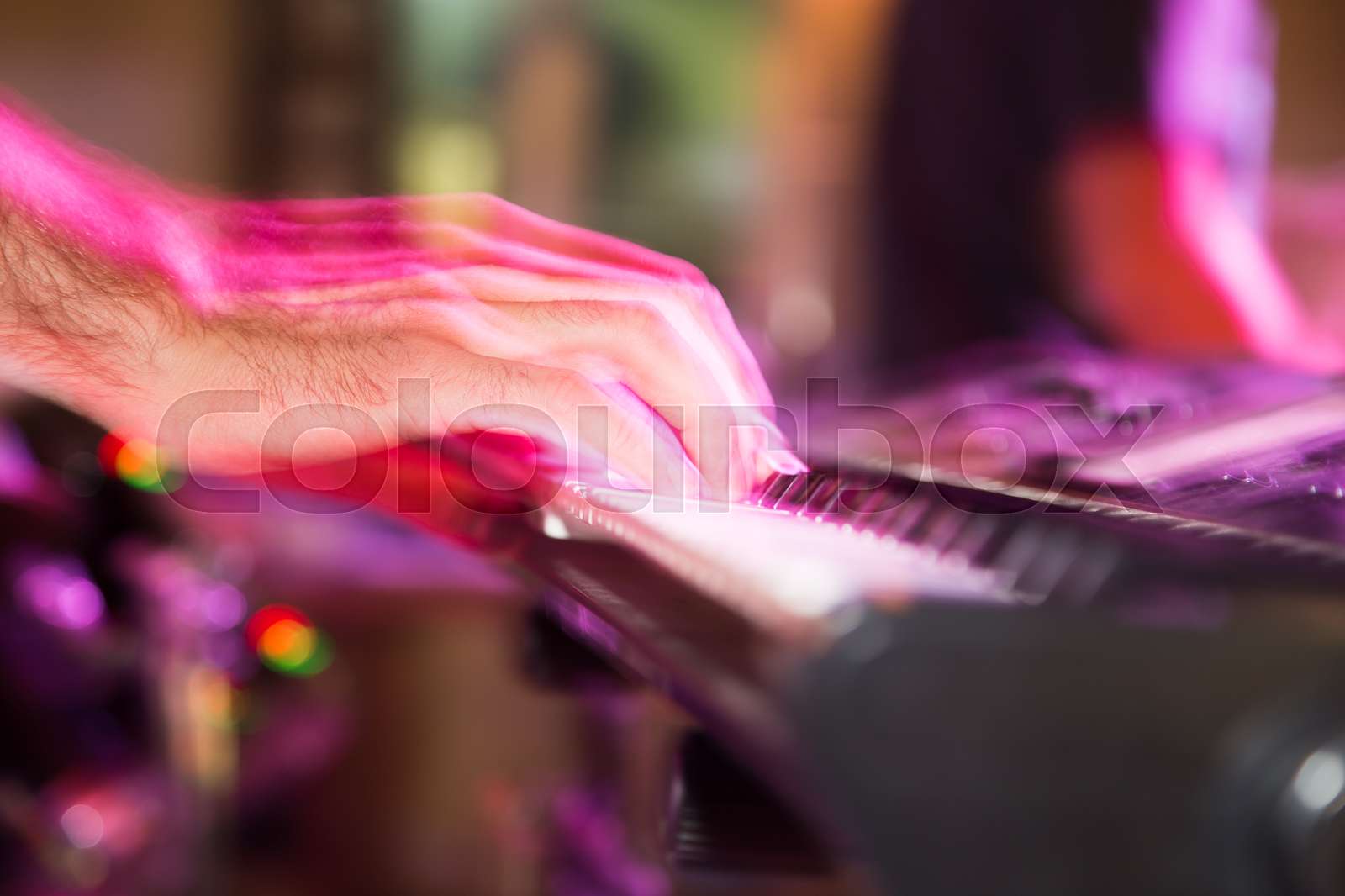 Musician plays keyboards in a rock band | Stock image | Colourbox