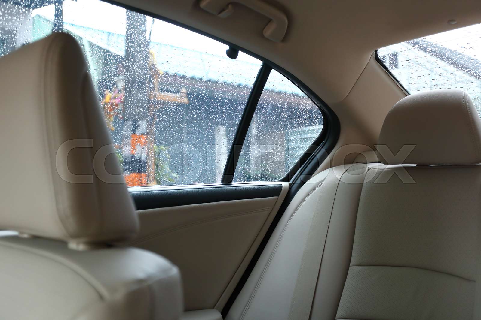 back seat inside vehicle car with rain drop on window Stock image