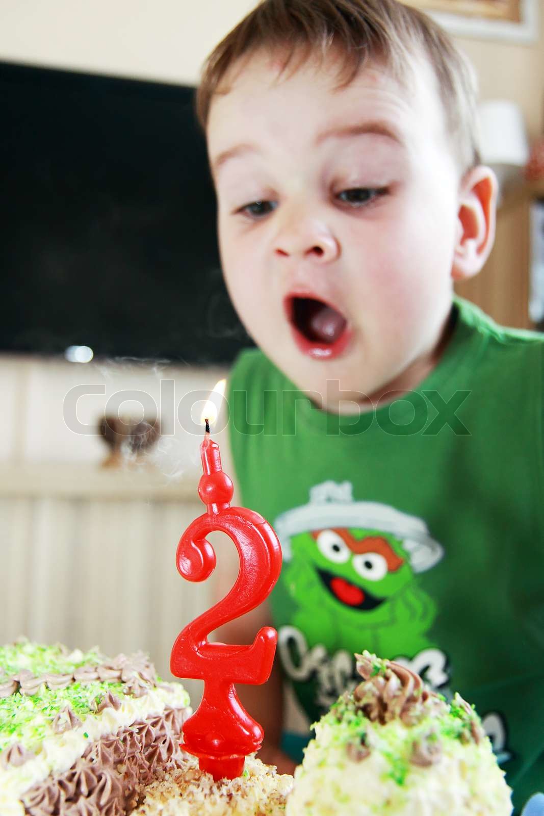child and birthday two year blowing candle Stock image Colourbox